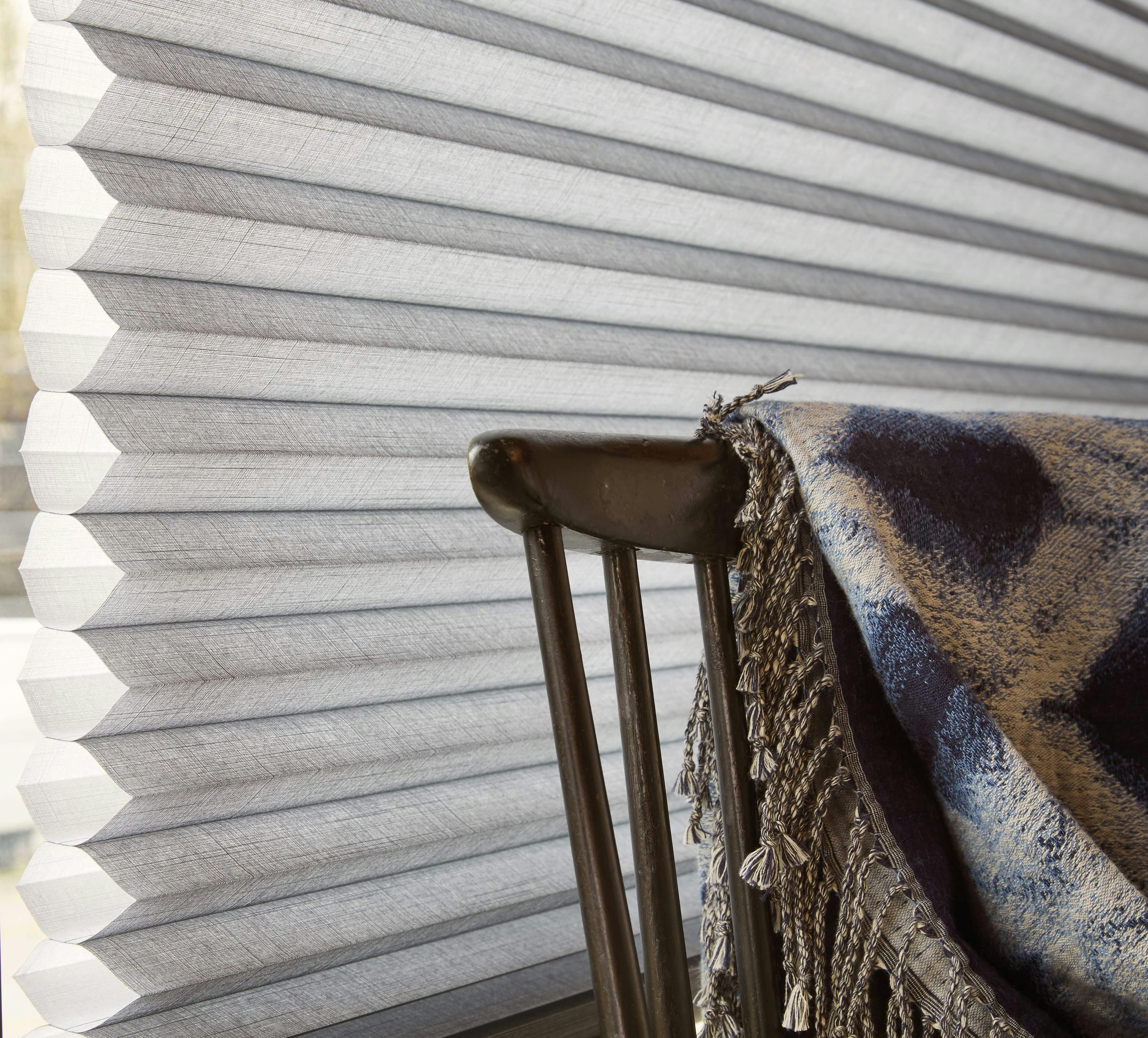 Side view of light grey Duette® blinds on a window
