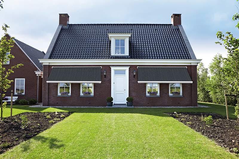 black awnings on brown home 