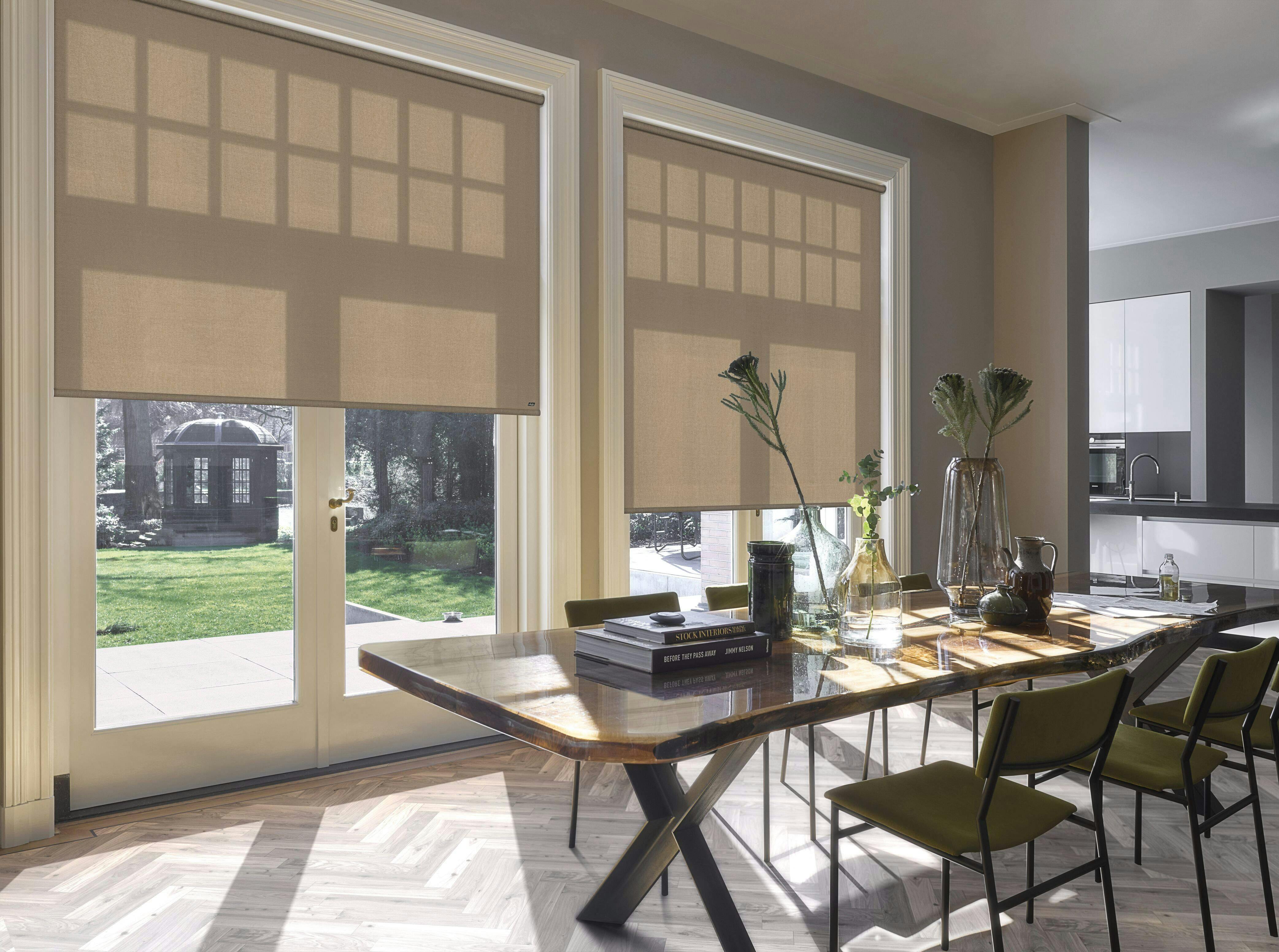 Light dining room with cream acoustic Roller blinds o windows and patio doors