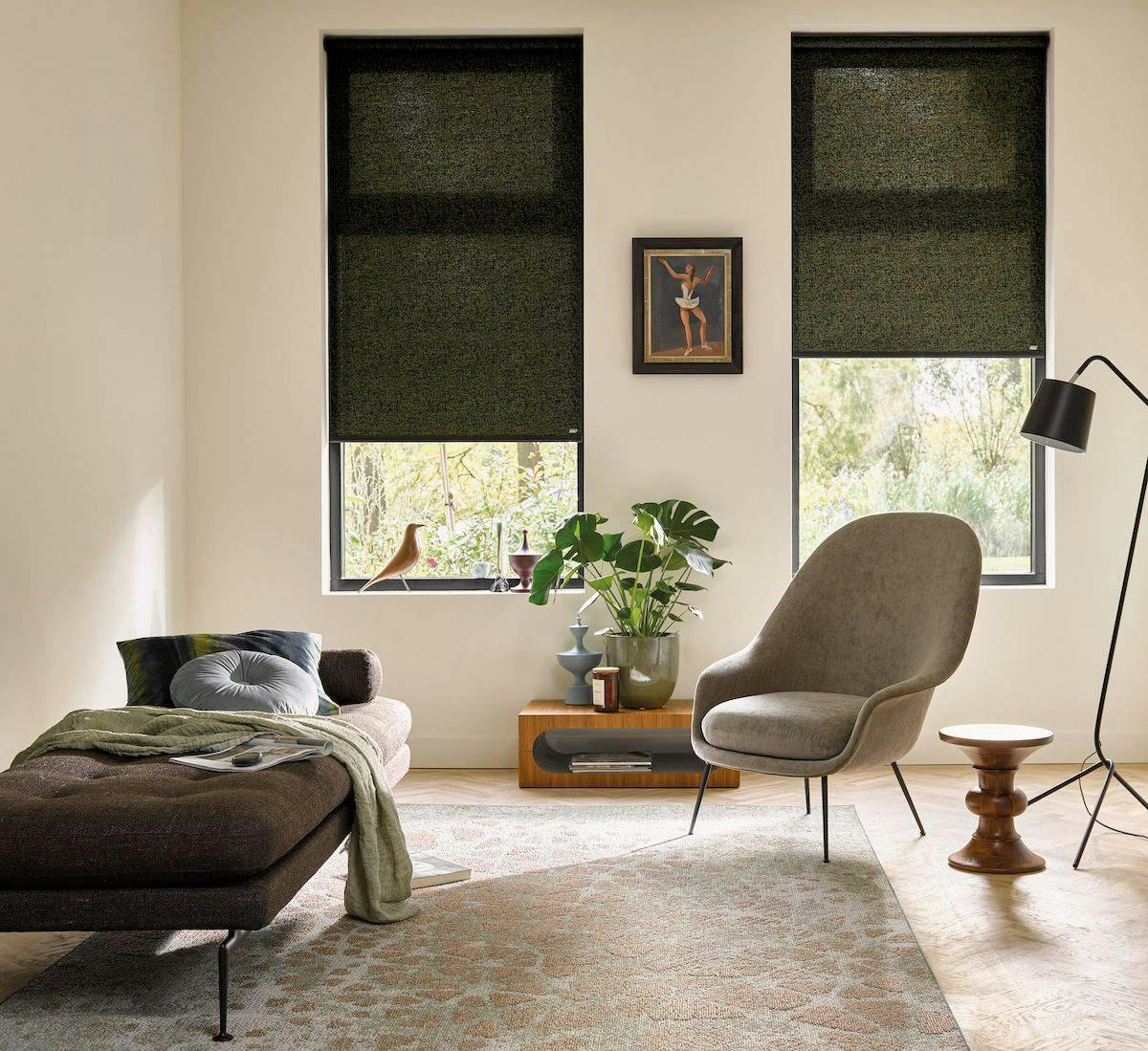 A spacious room with green acoustic Roller blinds on standard windows