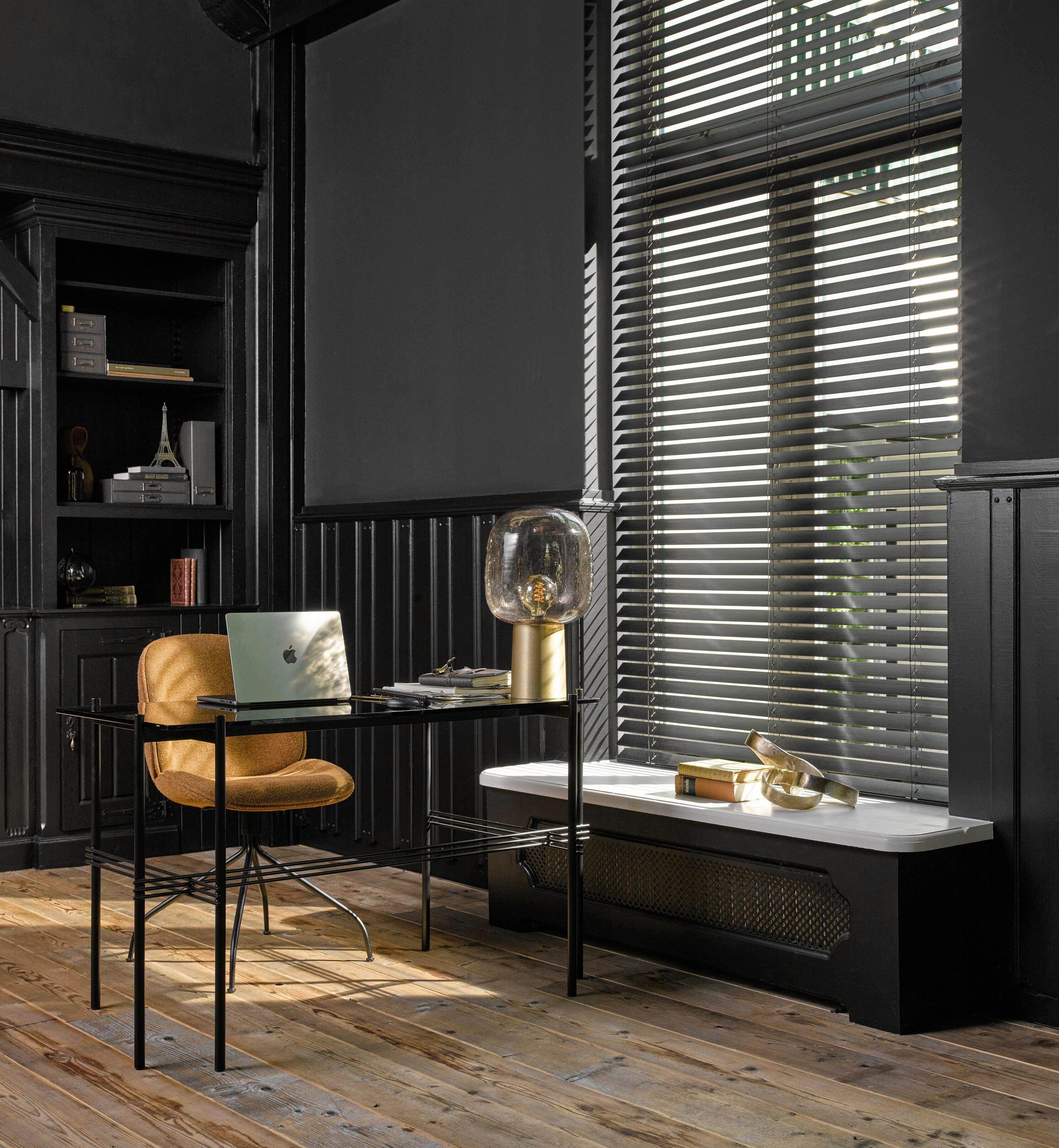 dark home office with black venetian blinds