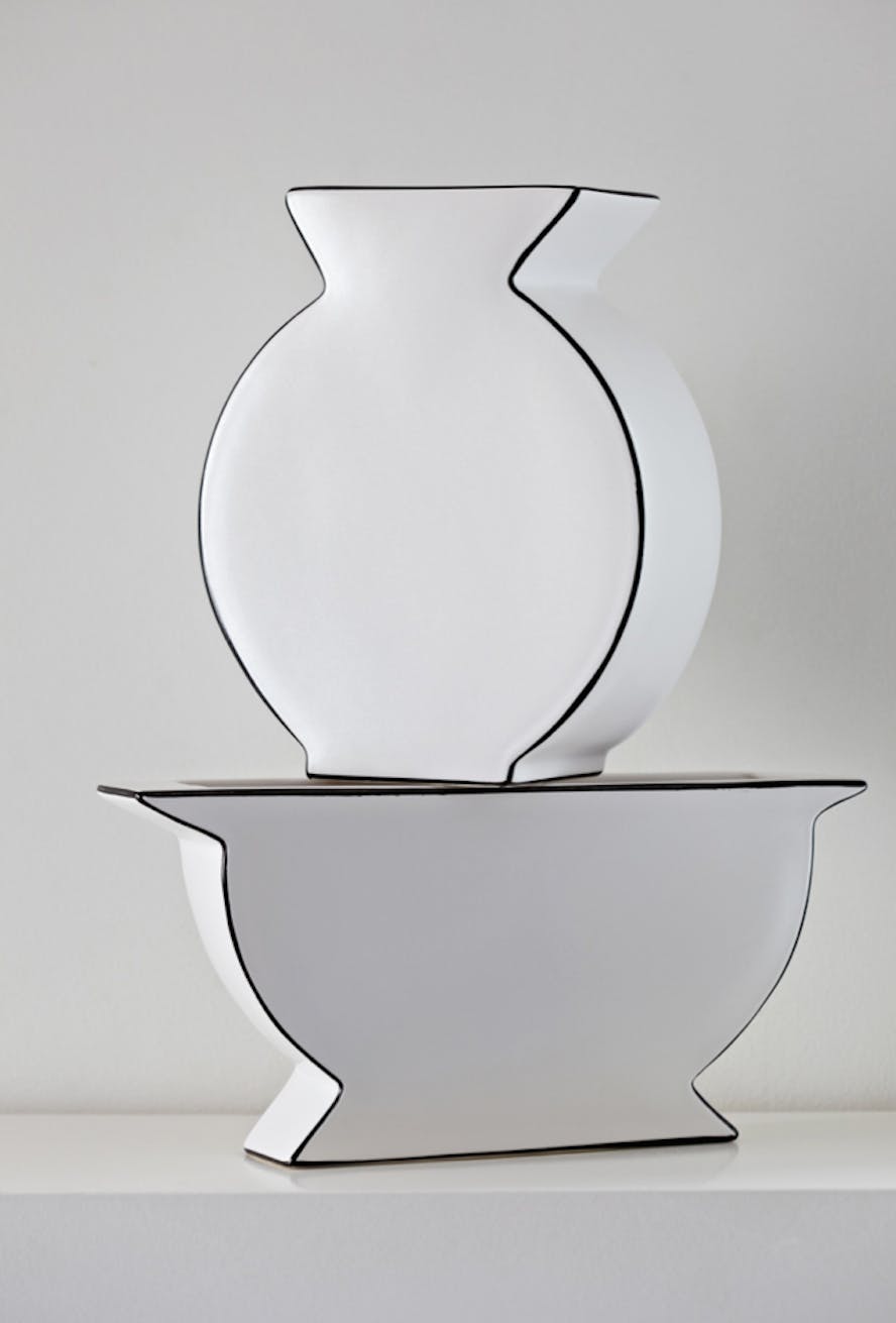 living room with white vase on a white mantlepiece