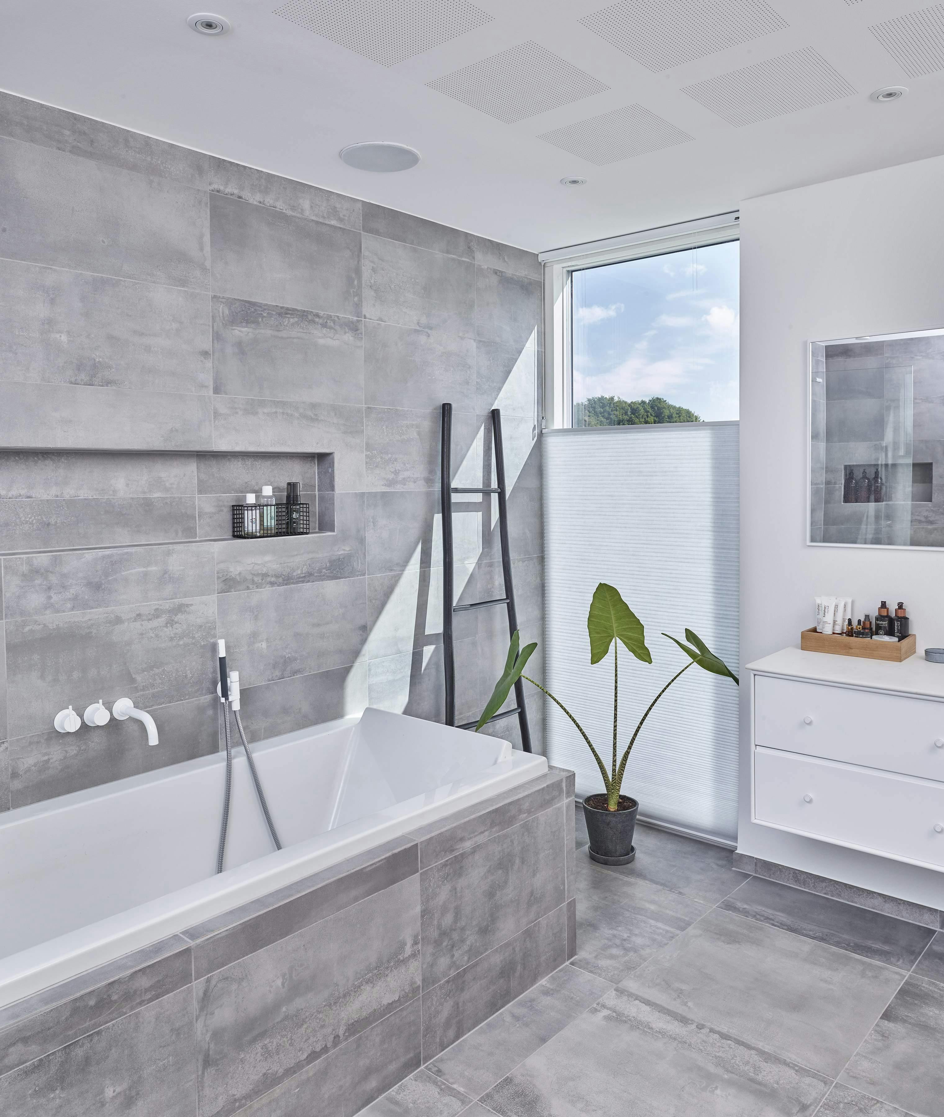 Grey bathroom with white Duette® blinds on a window