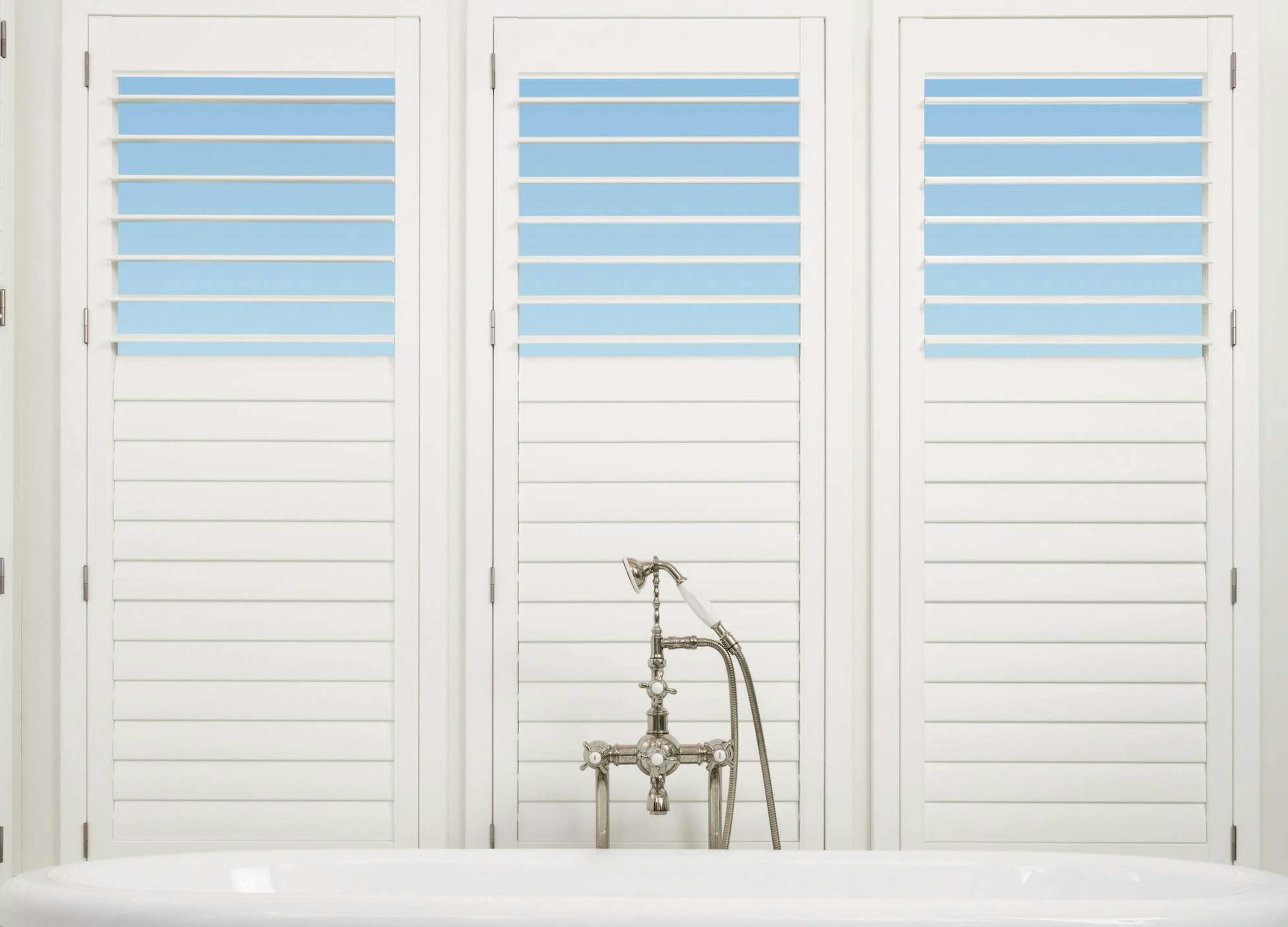 White bathroom with white Shutters on windows