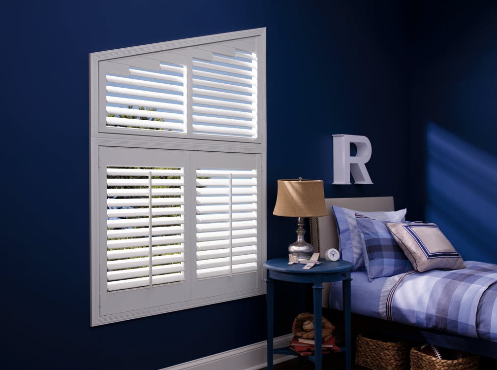 Dark blue bedroom with white Wooden blinds on windows