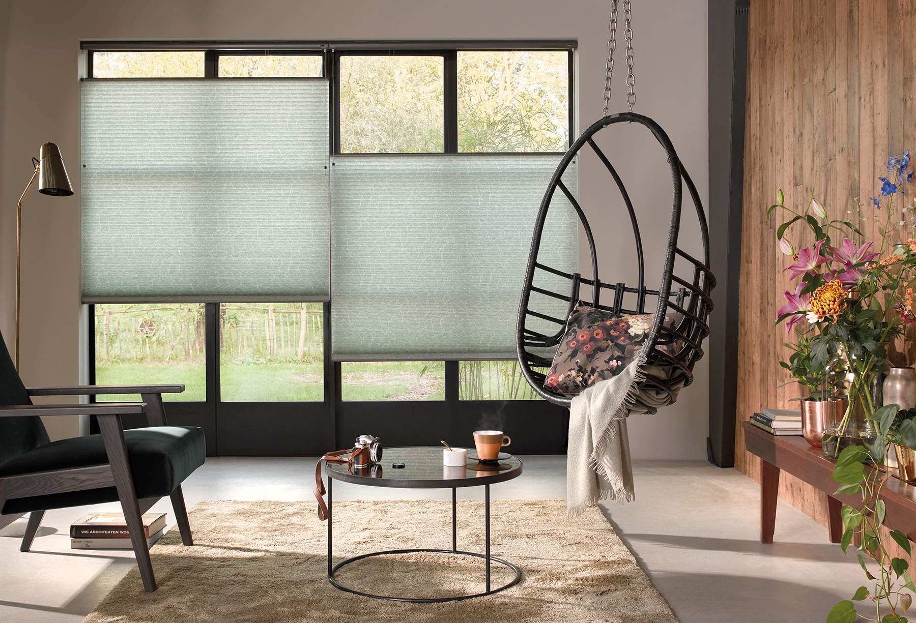 Modern living room with light green Duette® Blinds on windows 