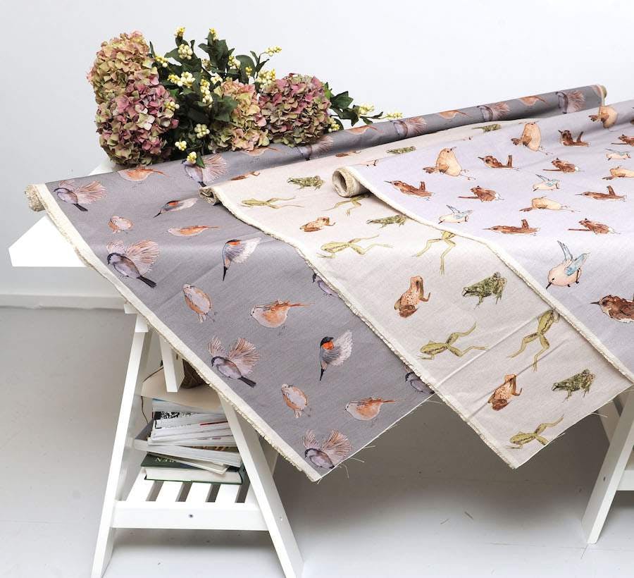 Fabric of various colours with birds on it 