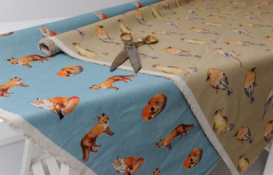 Blue fabric with foxes and beige fabric with birds