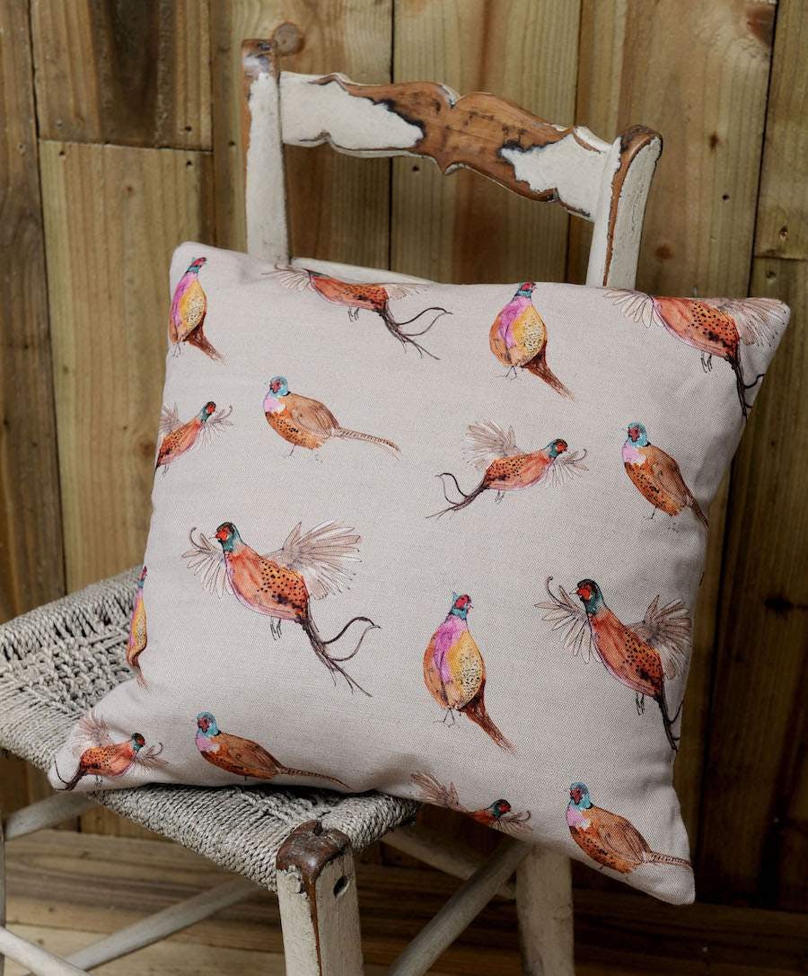 Cream cushion with bird prints on it