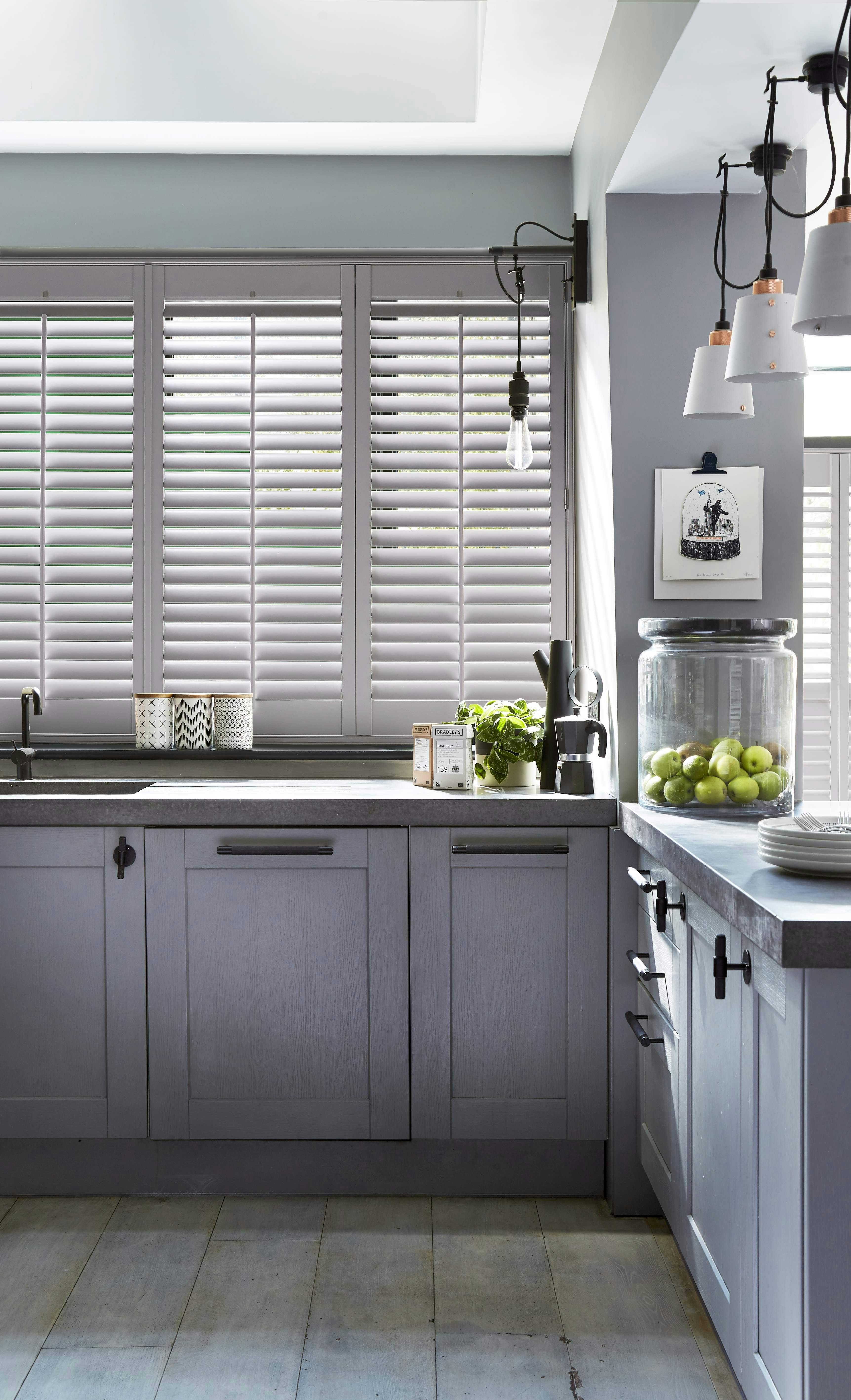 Grey kitchen with white Shutters on windows