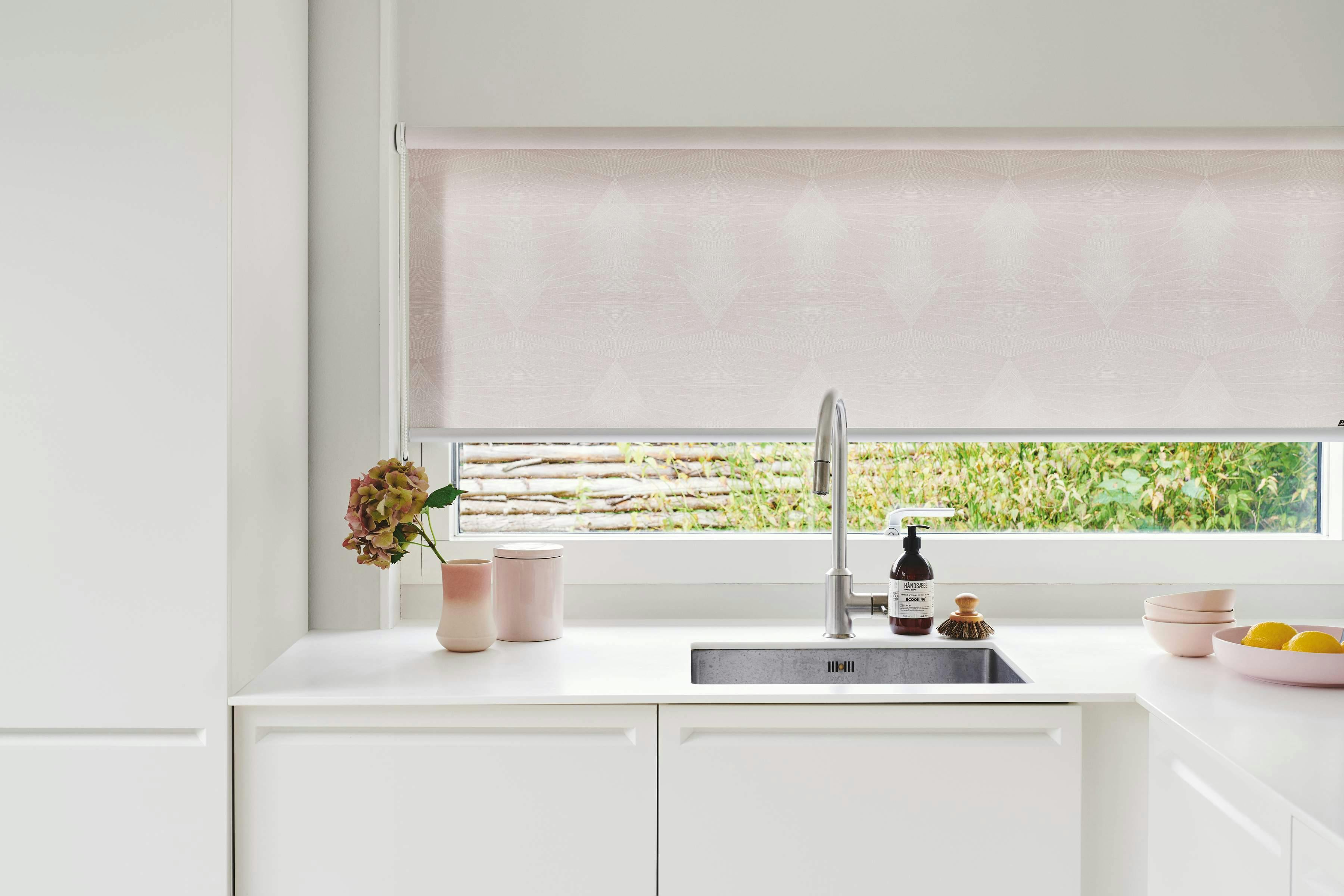 White modern kitchen with white Roller blinds on windows