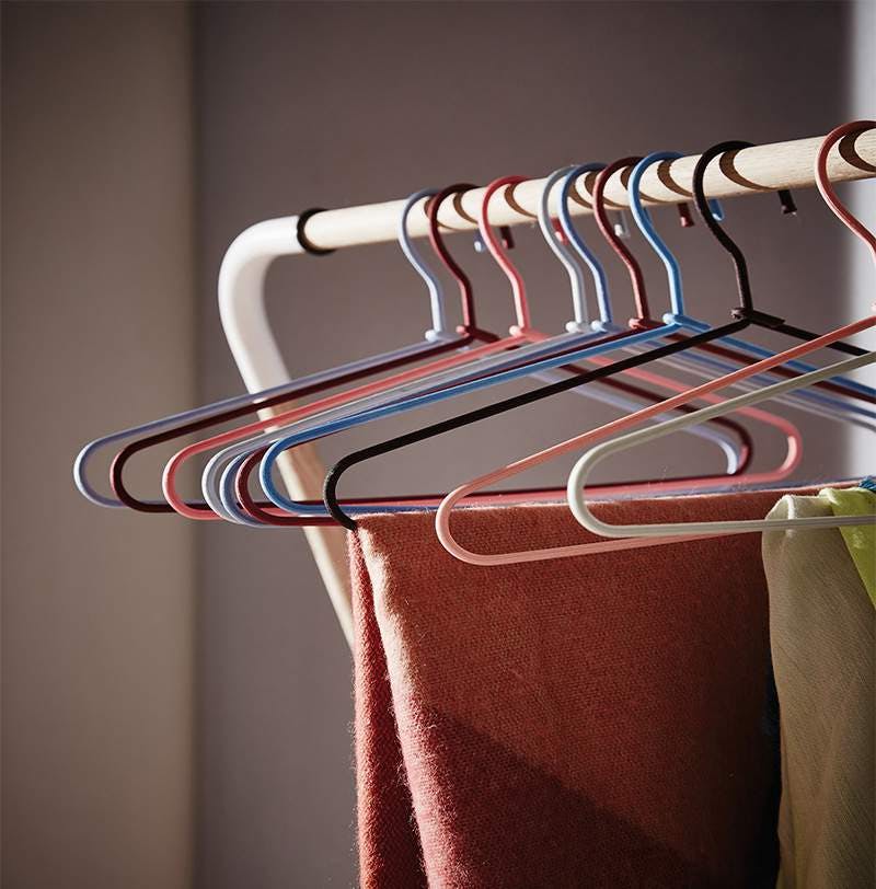 Hangers of various colours hanging on a rack
