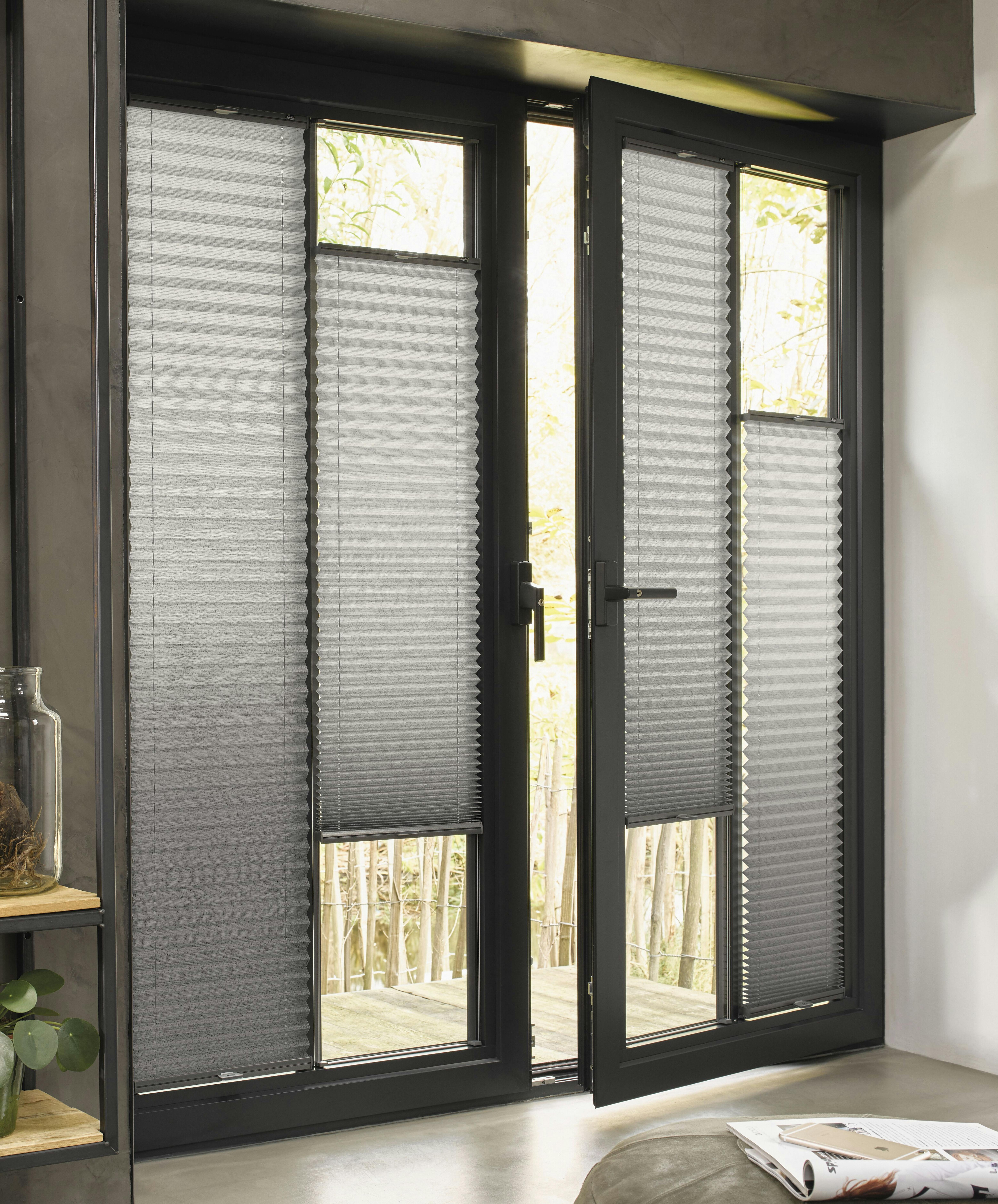 Modern living room with grey Plissé shades on screen doors