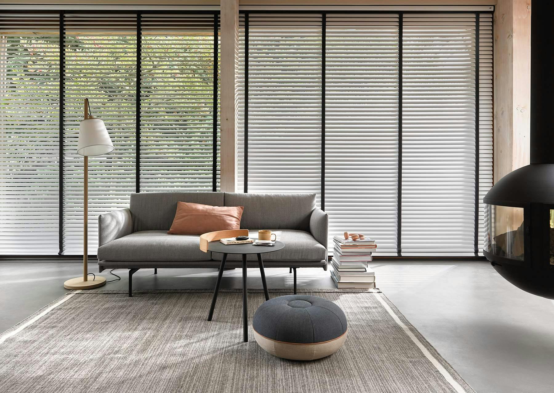 Modern living room with venetian blinds on large windows