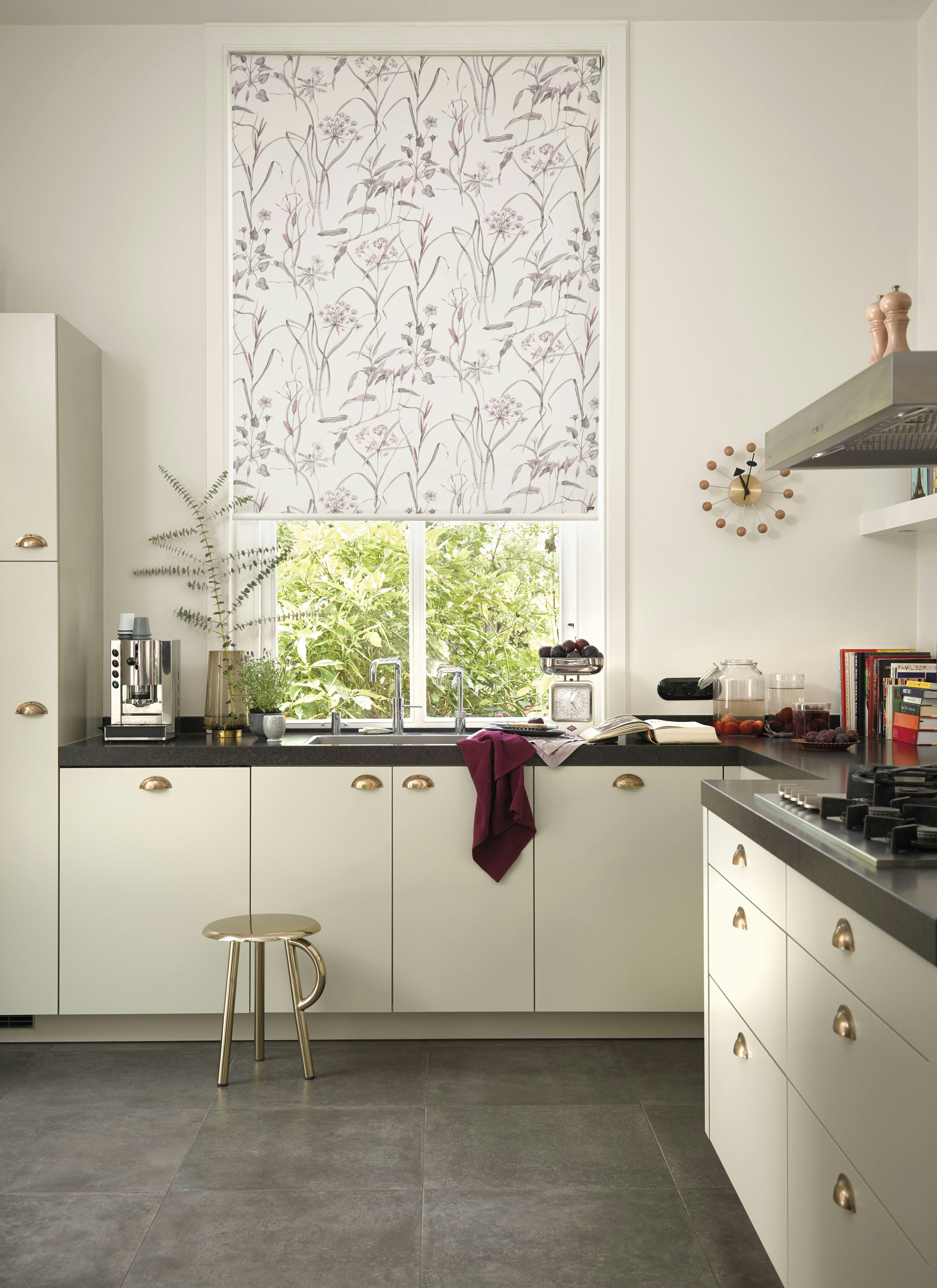 White kitchen with floral printed white and multi roller blinds