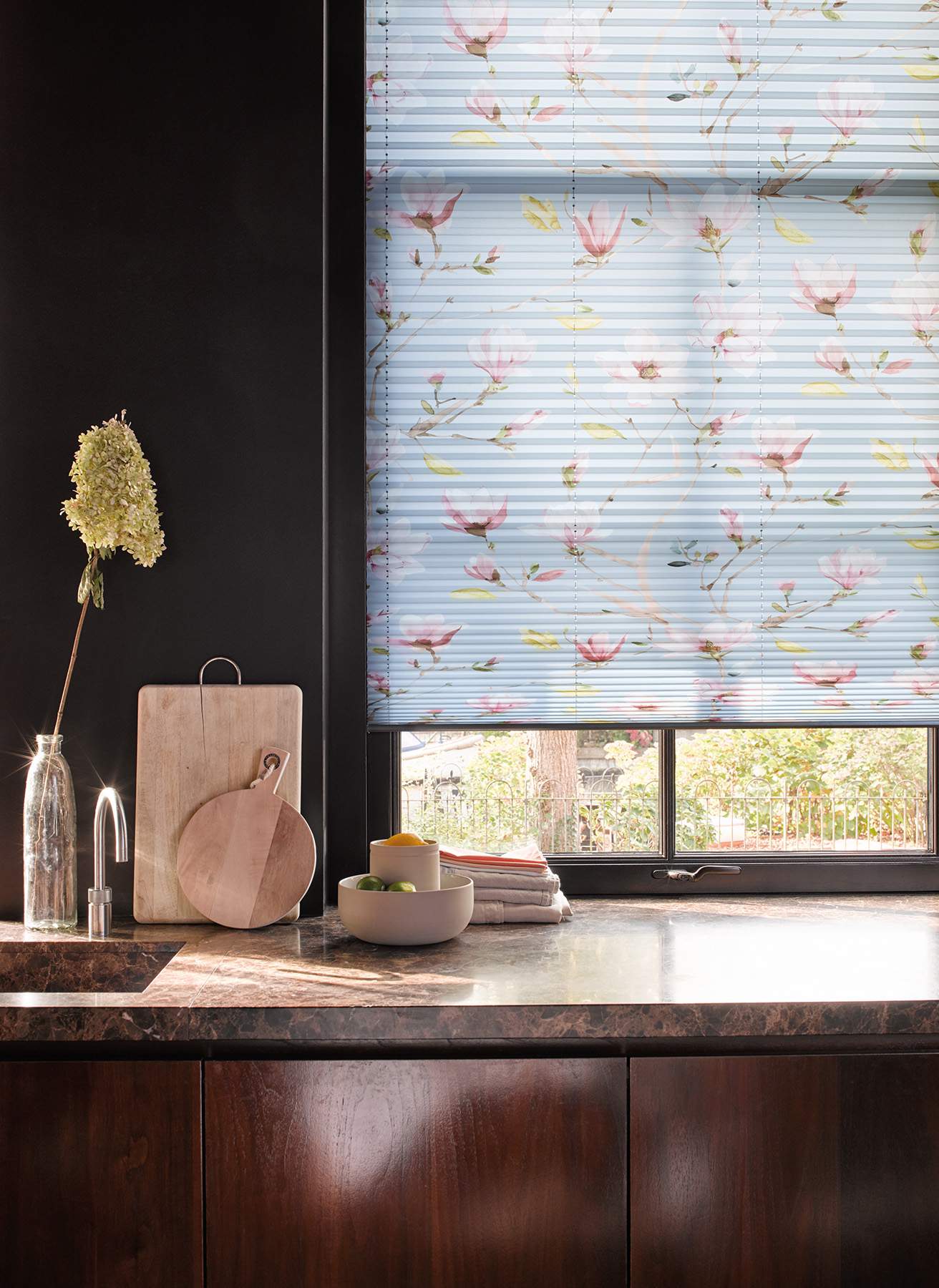 Modern kitchen with blue patterned Plissé blinds on standard windows
