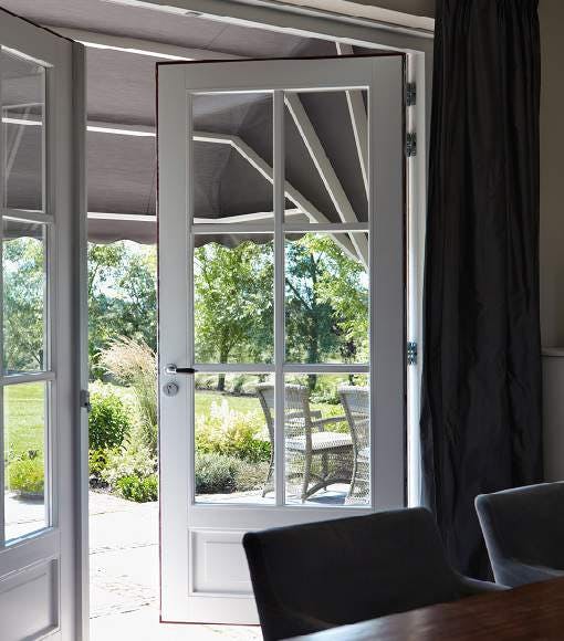 living room with french doors and grey canopy awnings