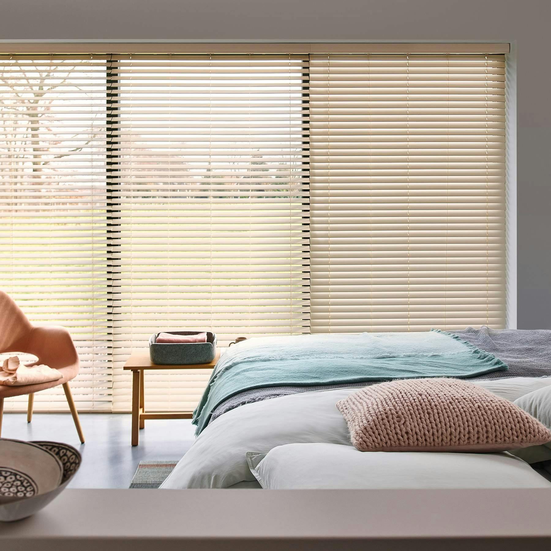 Light bedroom with cream Venetian blinds 