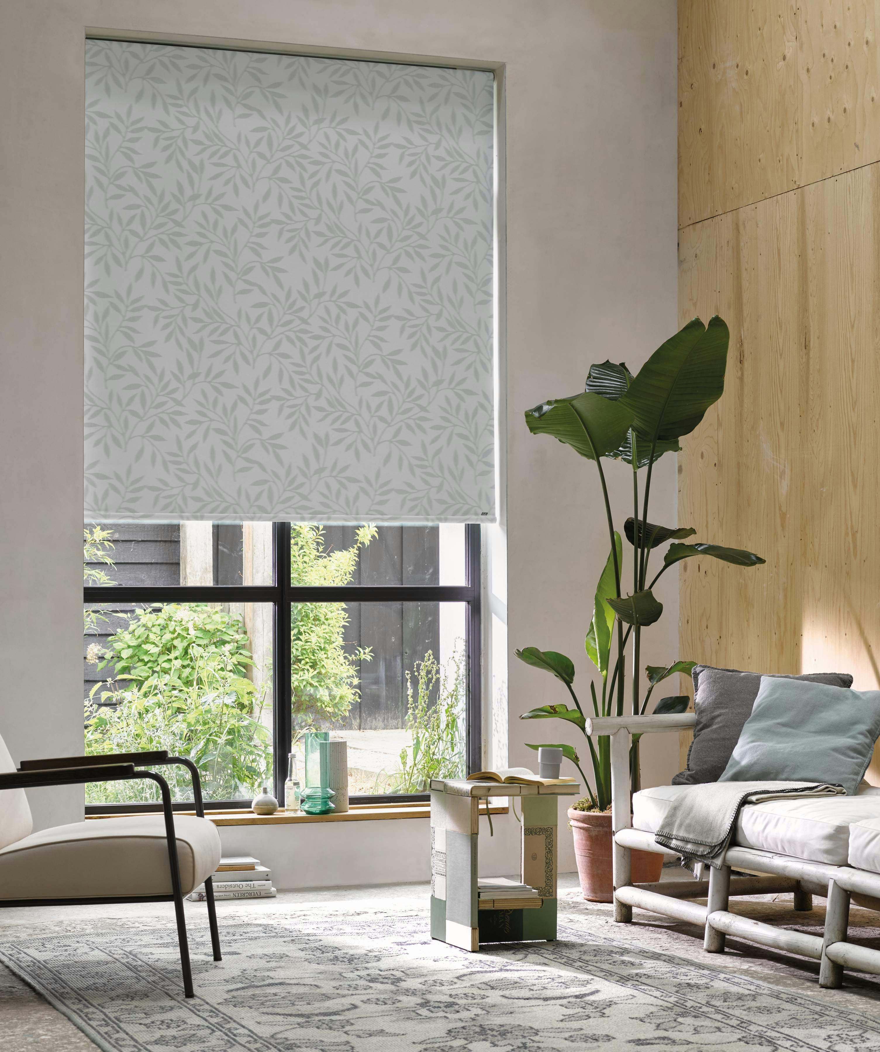 Modern living room with grey patterned roller blinds on a window