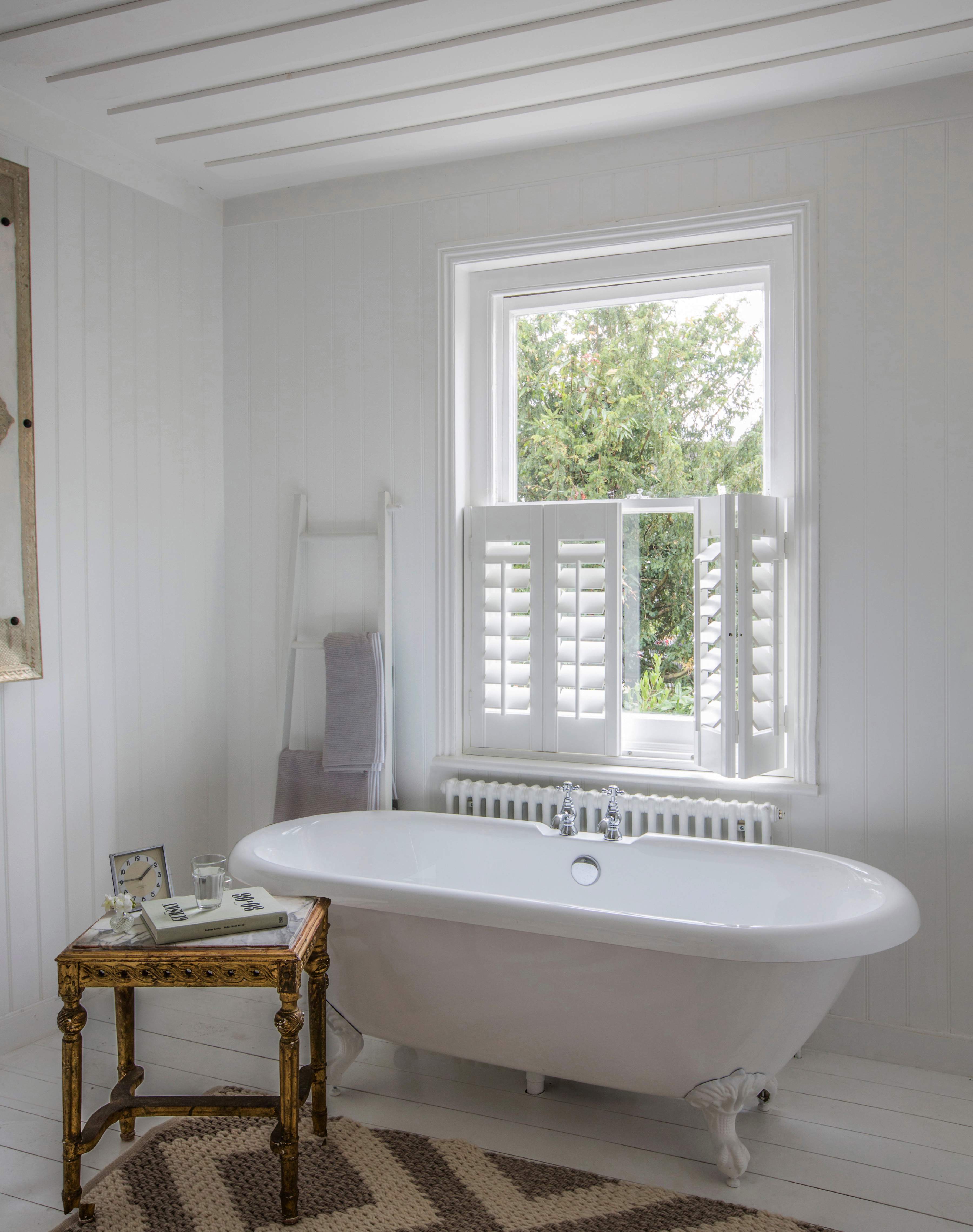 Bathroom with white cafe style Shutters