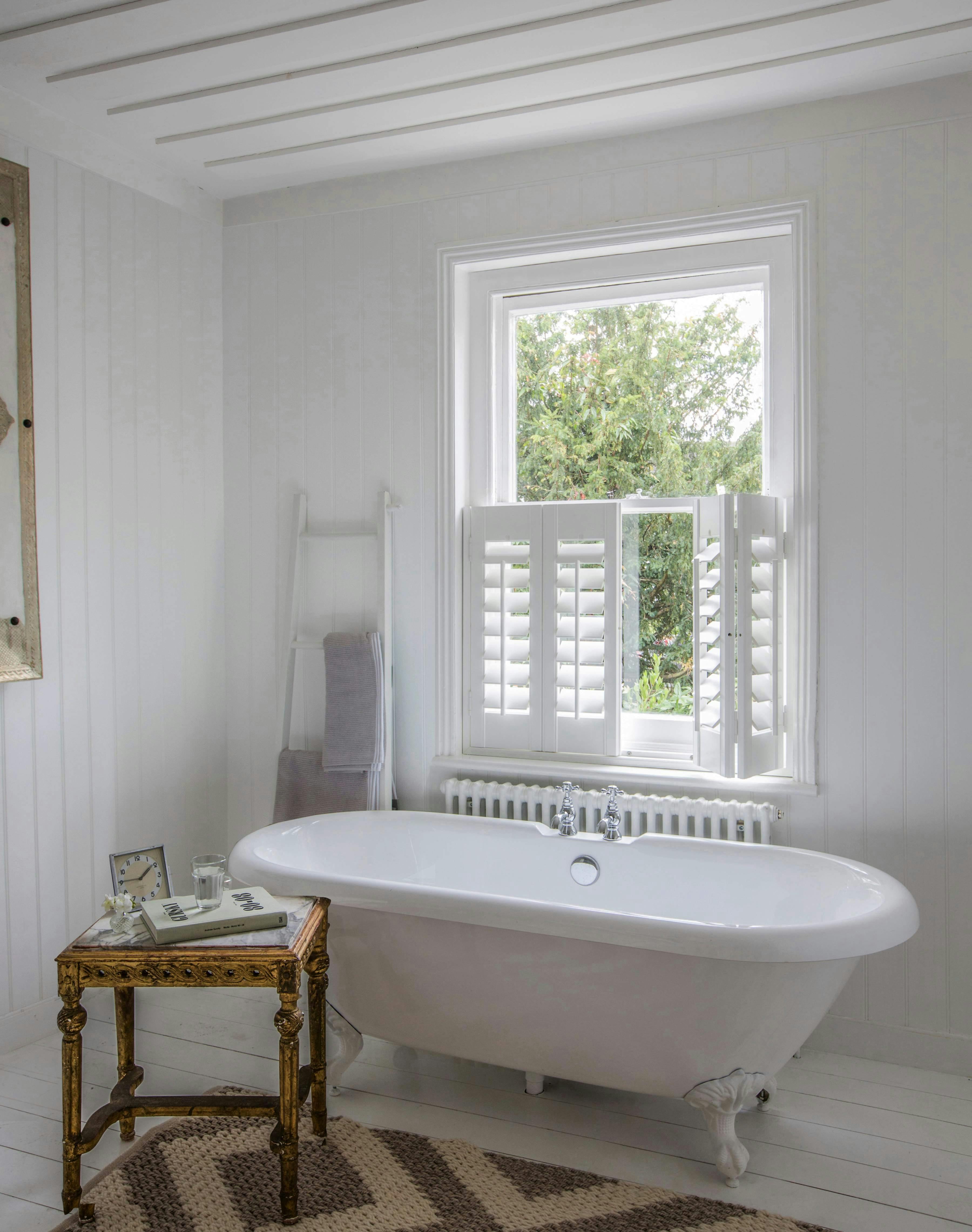 Bathroom with white cafe style Shutters