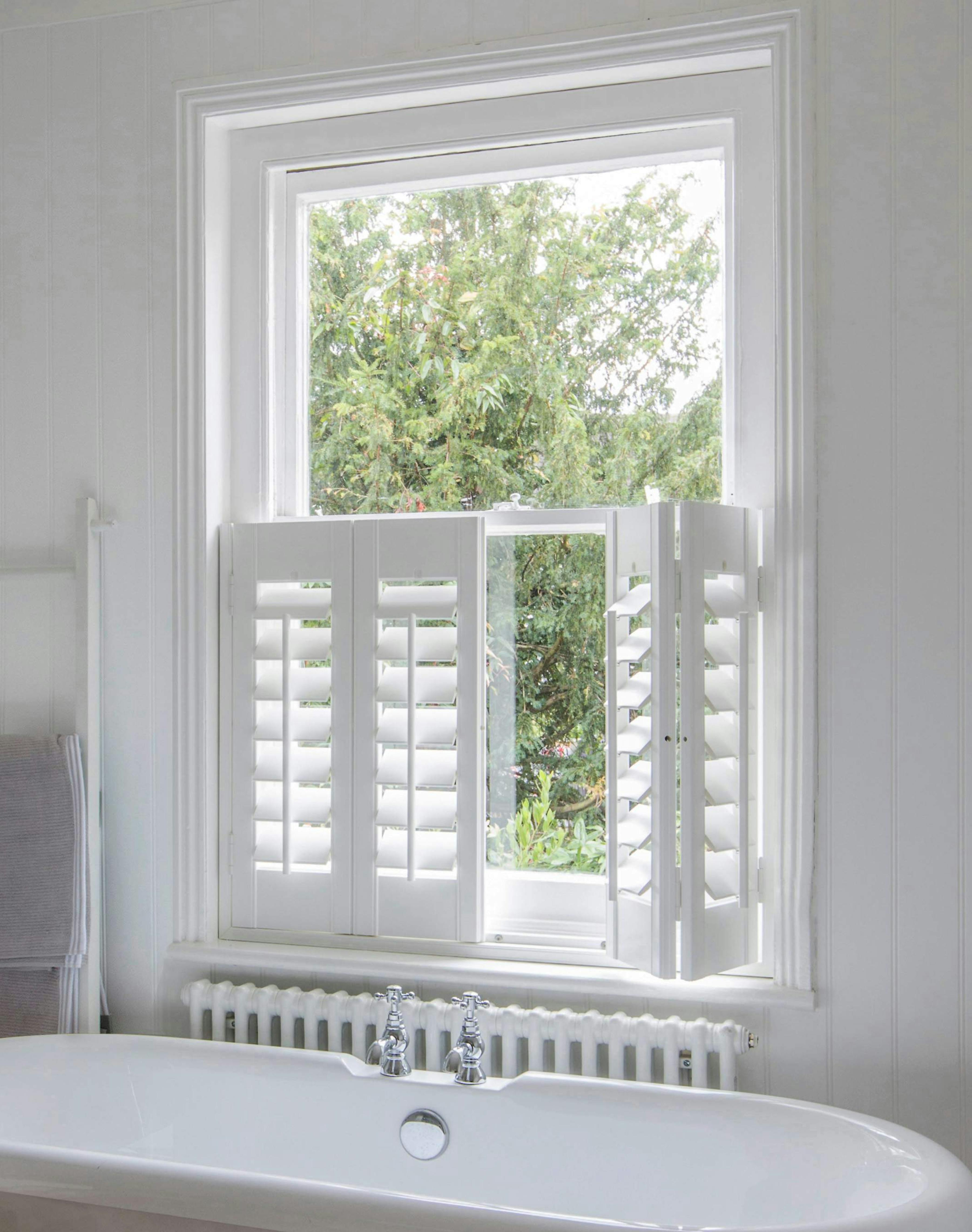Bathroom with white cafe style Shutters