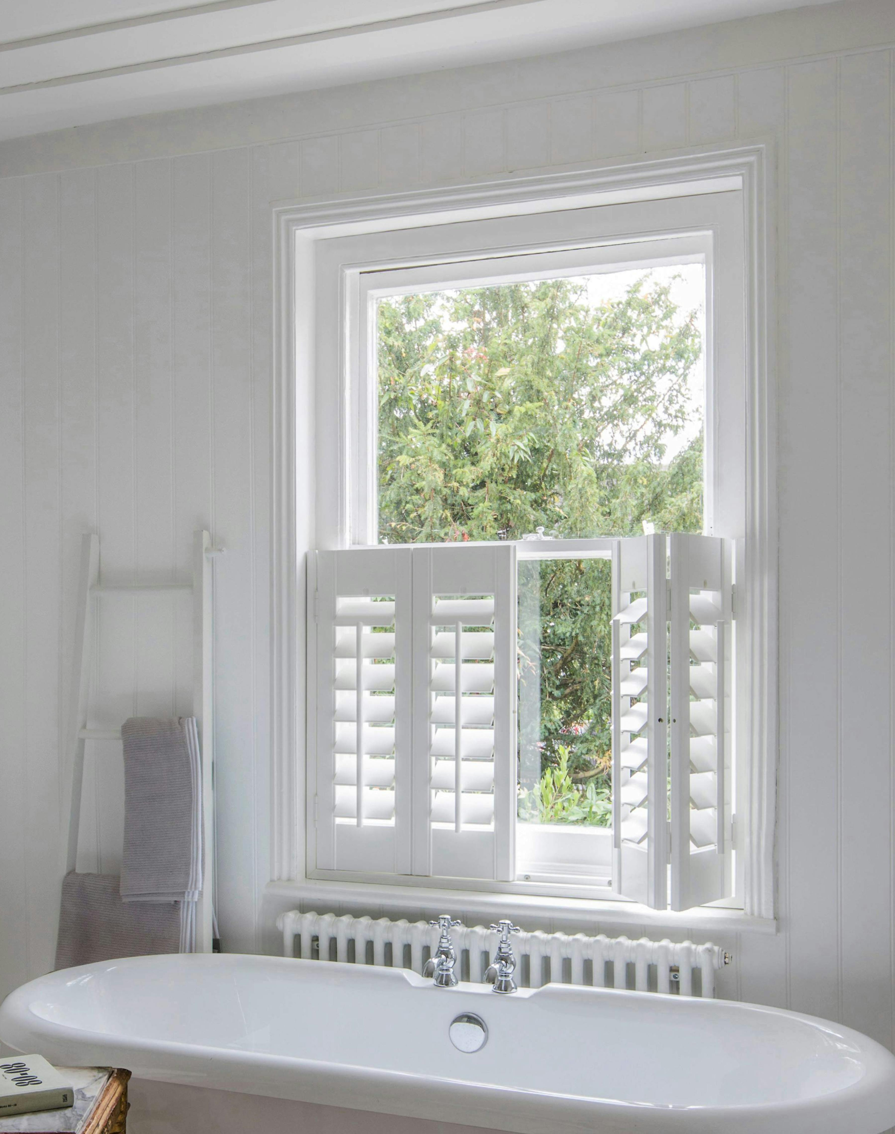 Bathroom with white cafe style Shutters