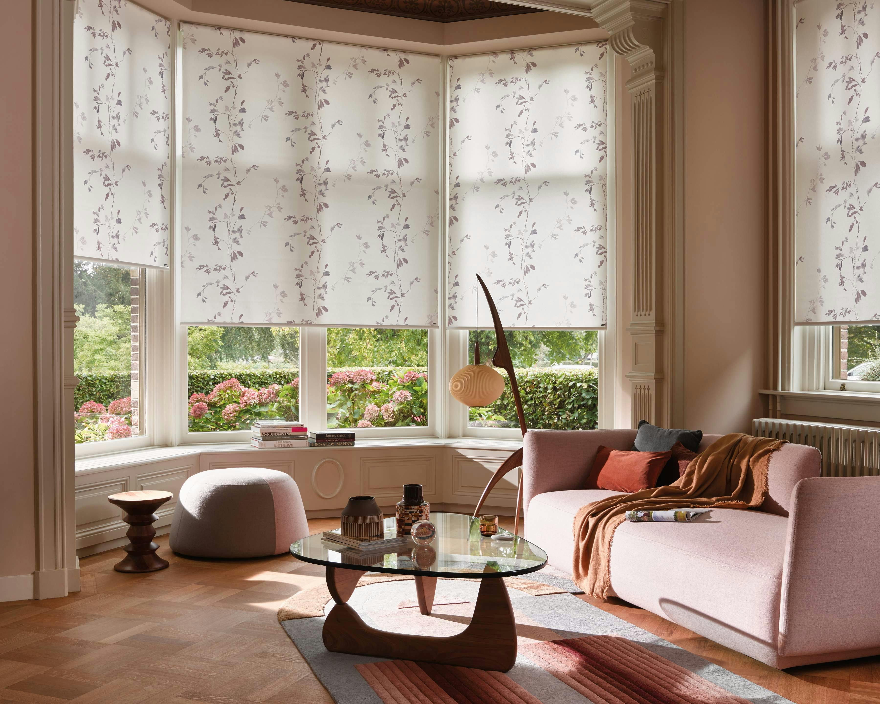 Pastel living room with cream patterened roller blinds on windows