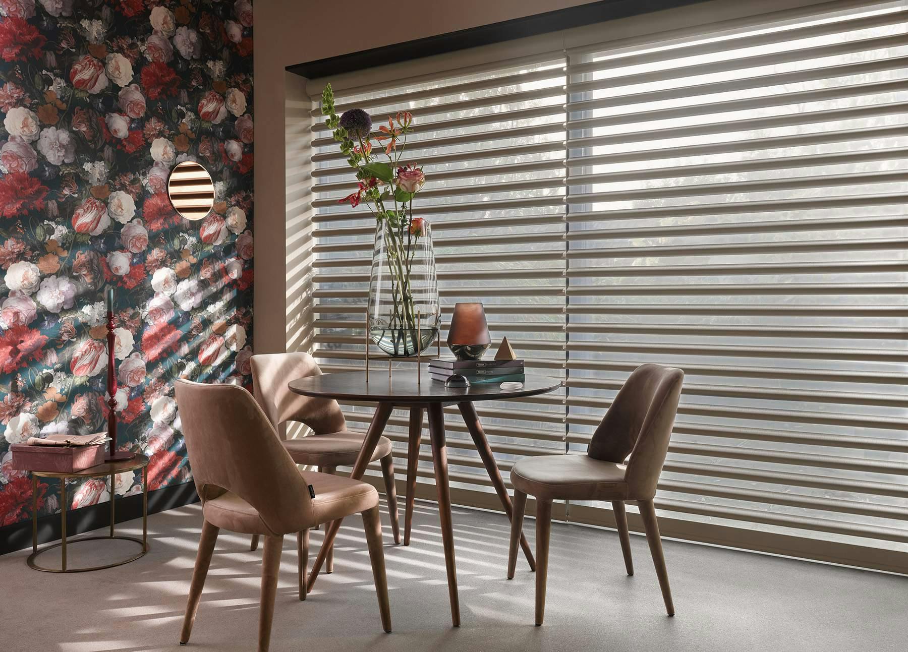 Modern dining room with grey Pirouette® Shades on large windows
