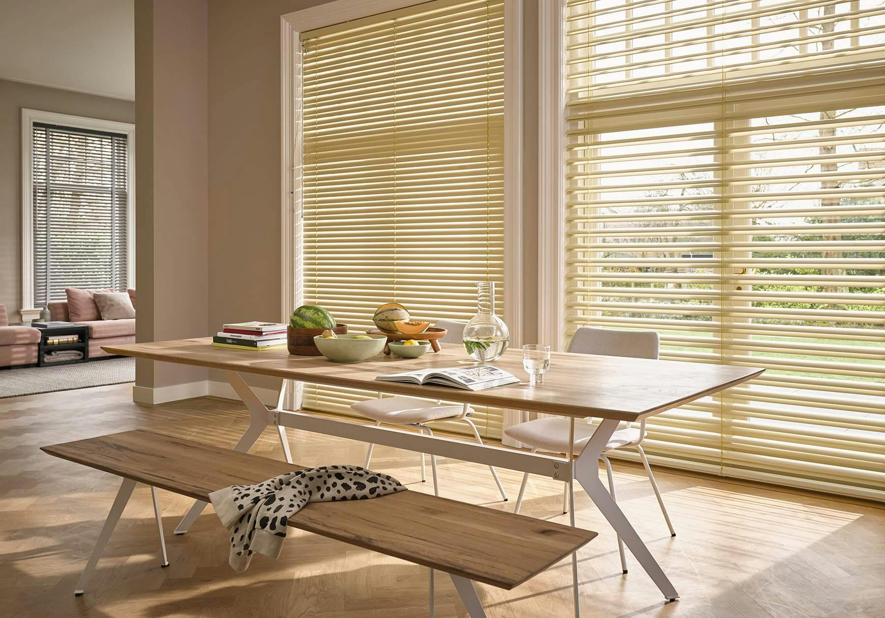 Bright dining room with yellow Venetian blinds on windows