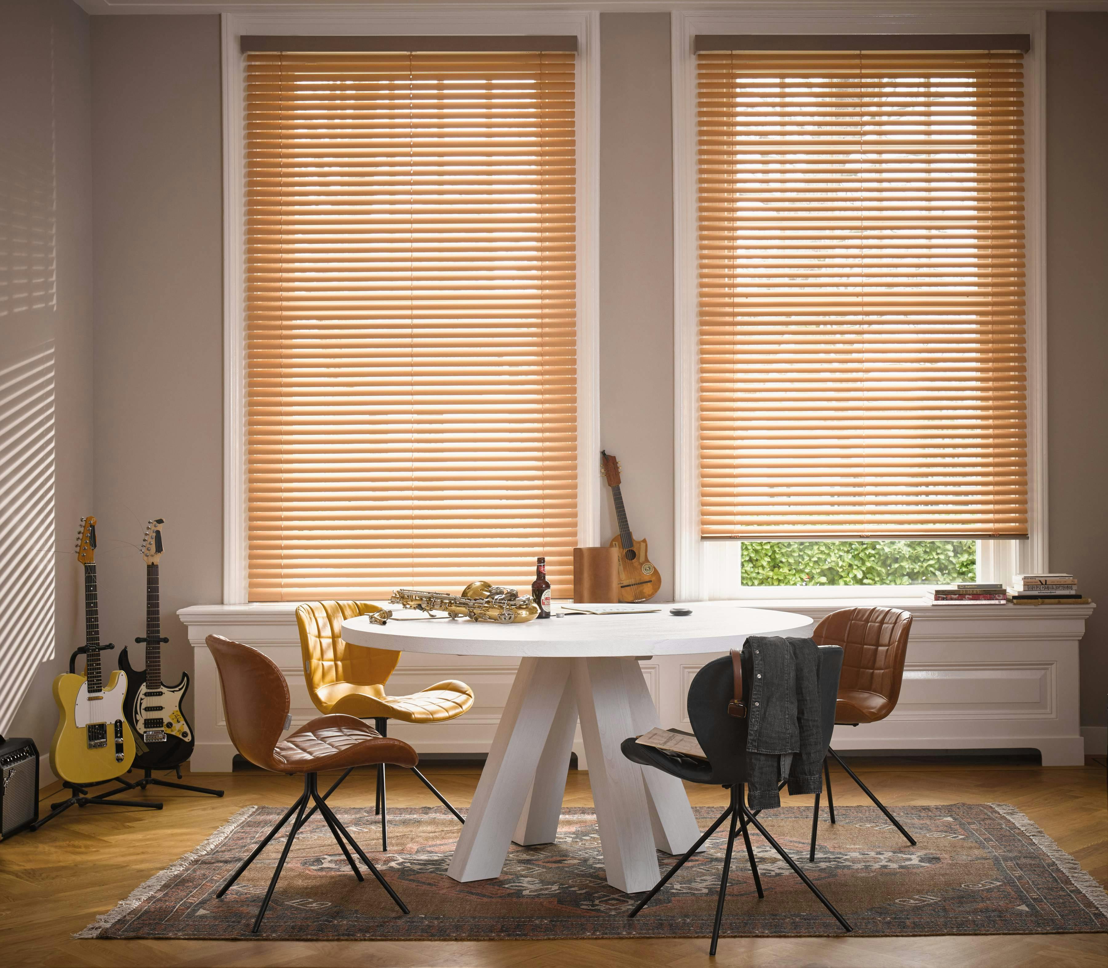 Bright dining room with yellow Venetian blinds on windows