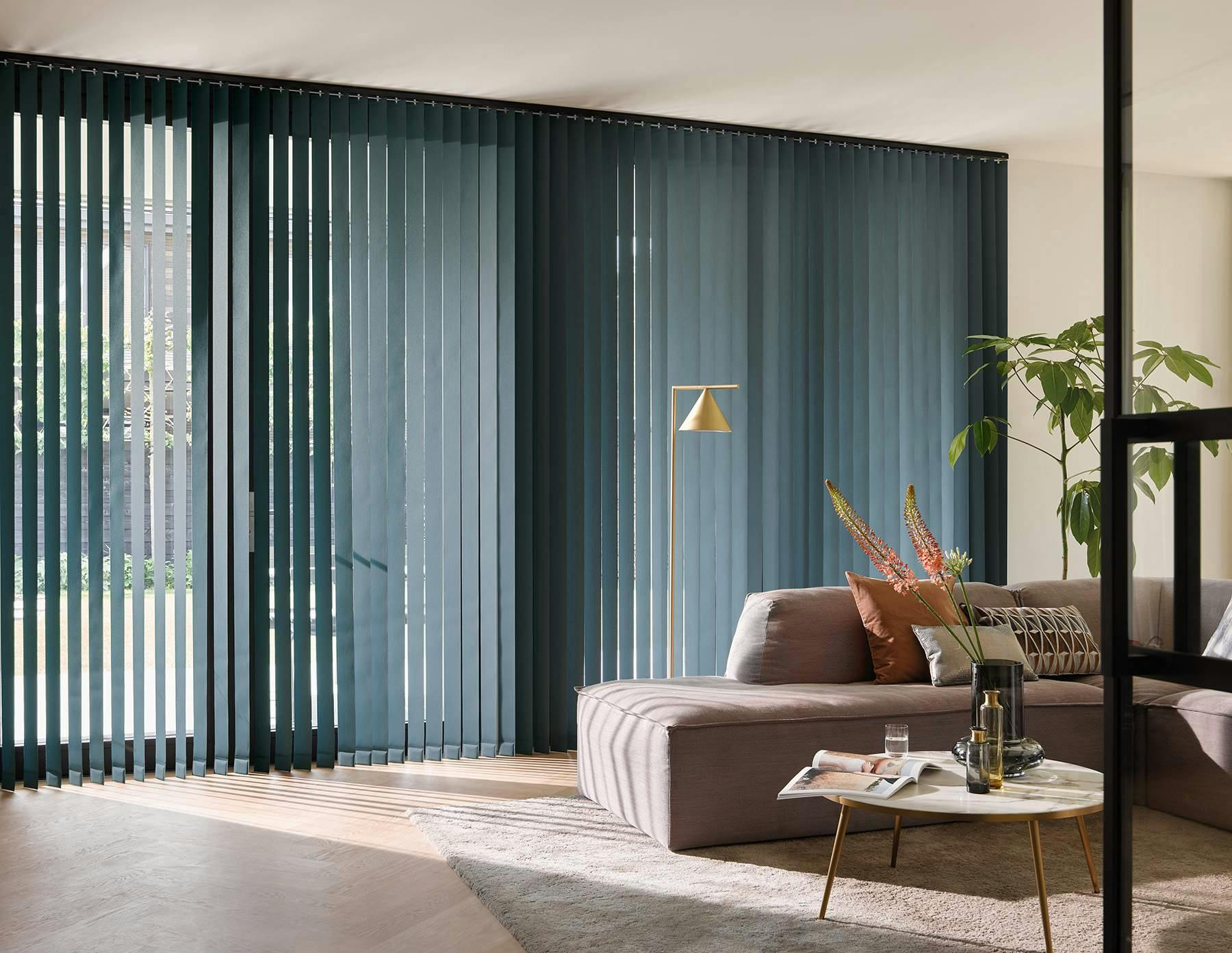 Modern living room with blue Vertical blinds on large windows