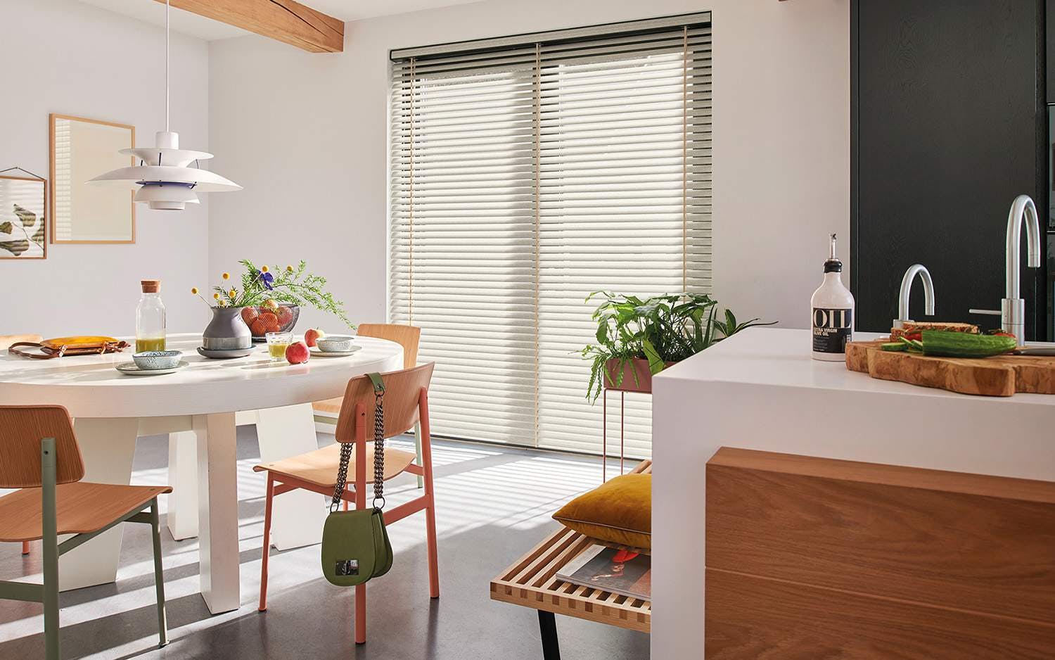 Light kitchen with white Venetian blinds on a window 