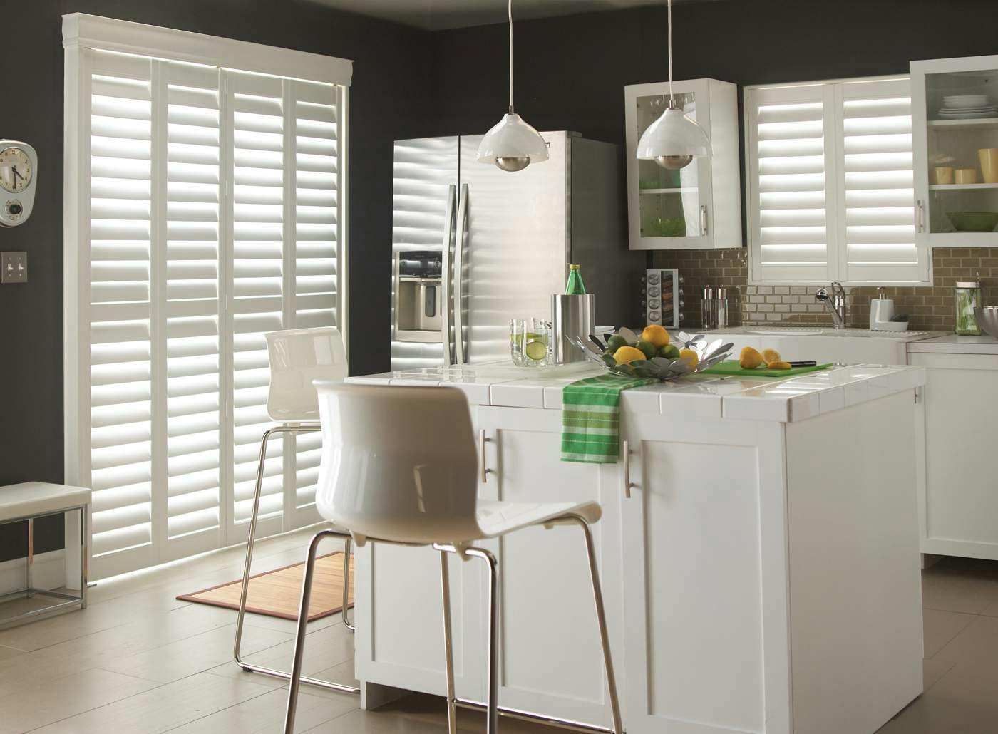 White kitchen with white Shutters on windows 