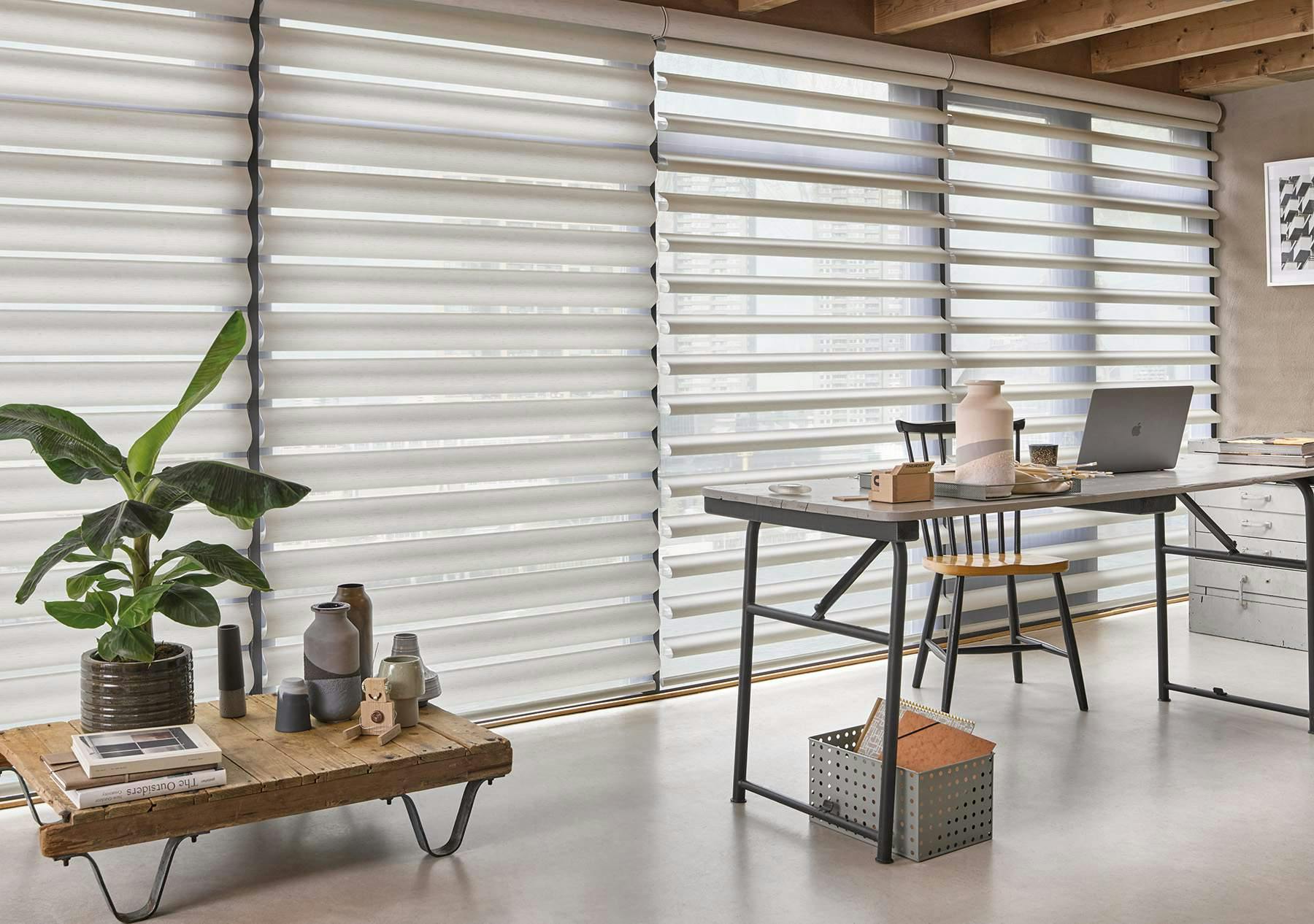 Light contemporary kitchen with white Pirouette® shades on large windows