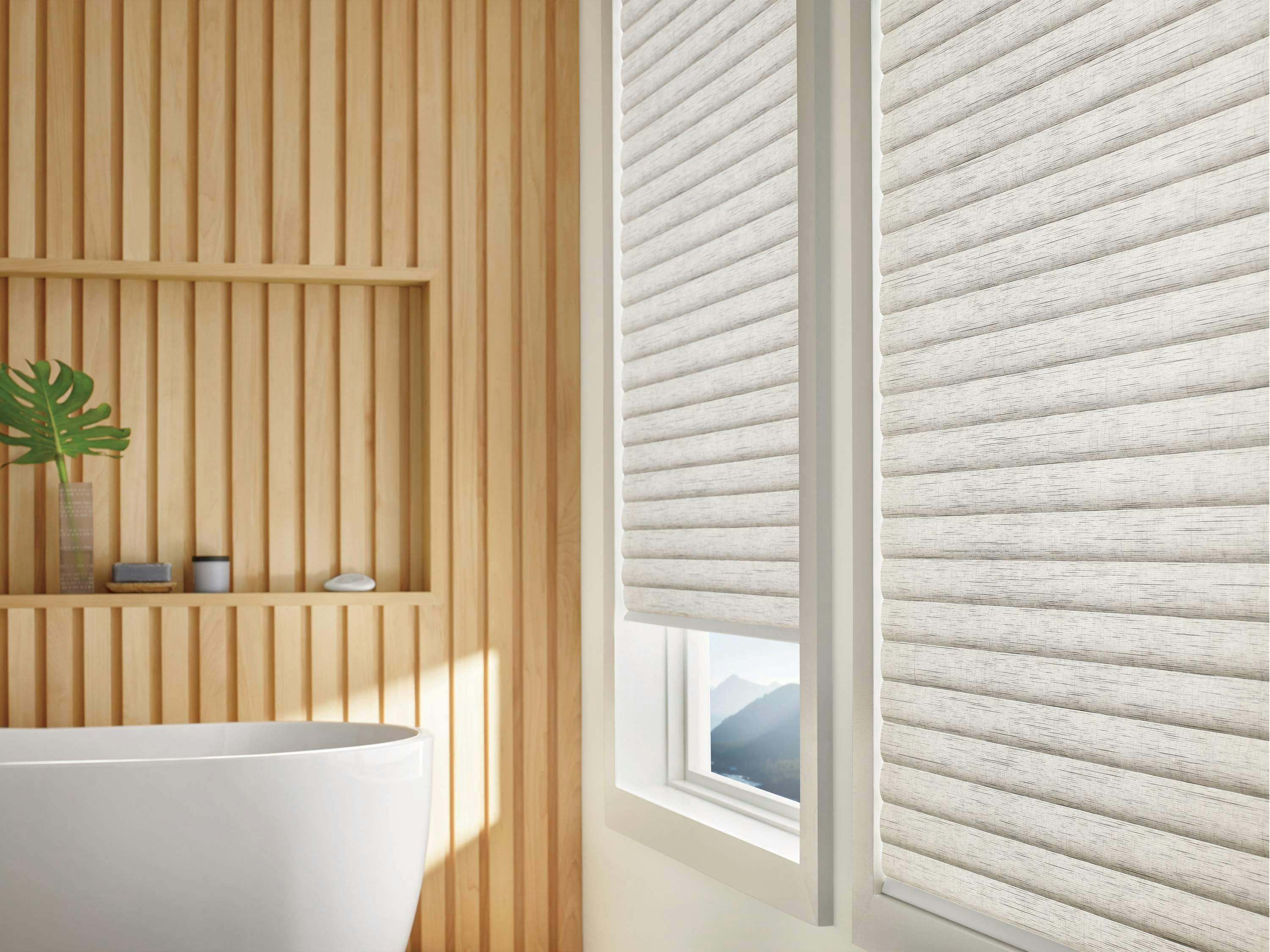 Light bathroom with cream Sonnette® shades on windows
