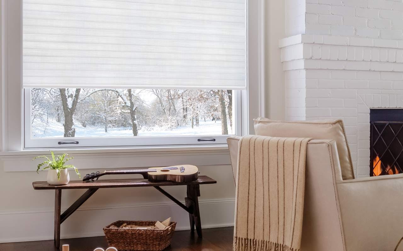 Cosy living room with white Sonnette™ shades on a window