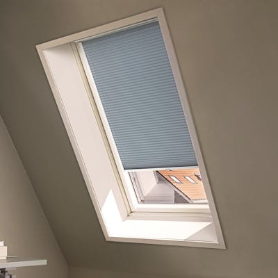 Blue duette shades on a skylight window