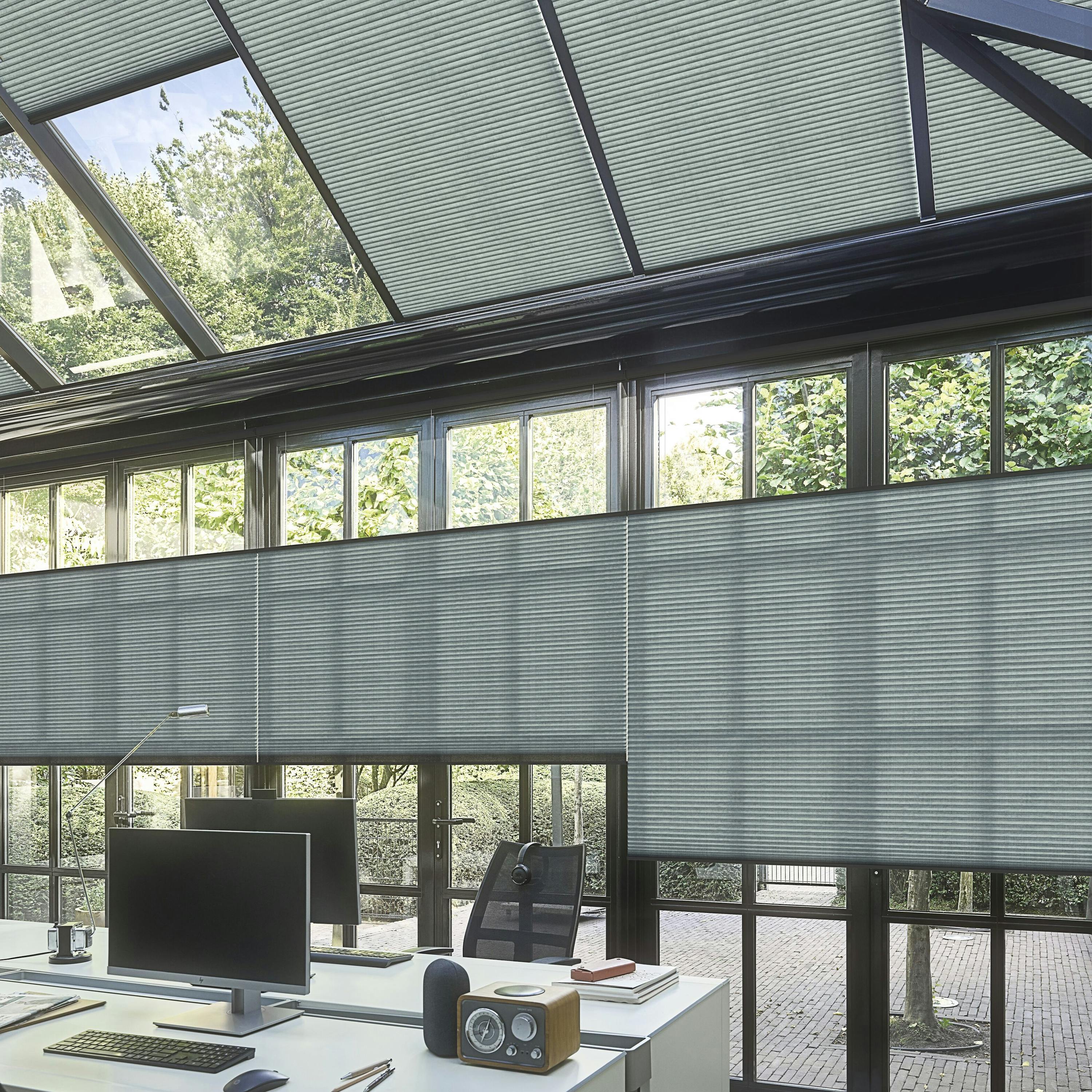 Dark green re-life duette shades on a conservatory home office