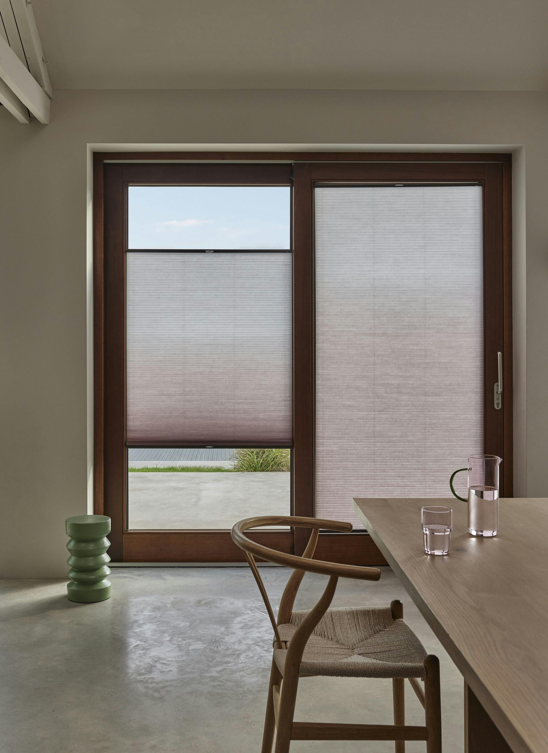 Light Duette® blinds on a patio door in a modern kitchen