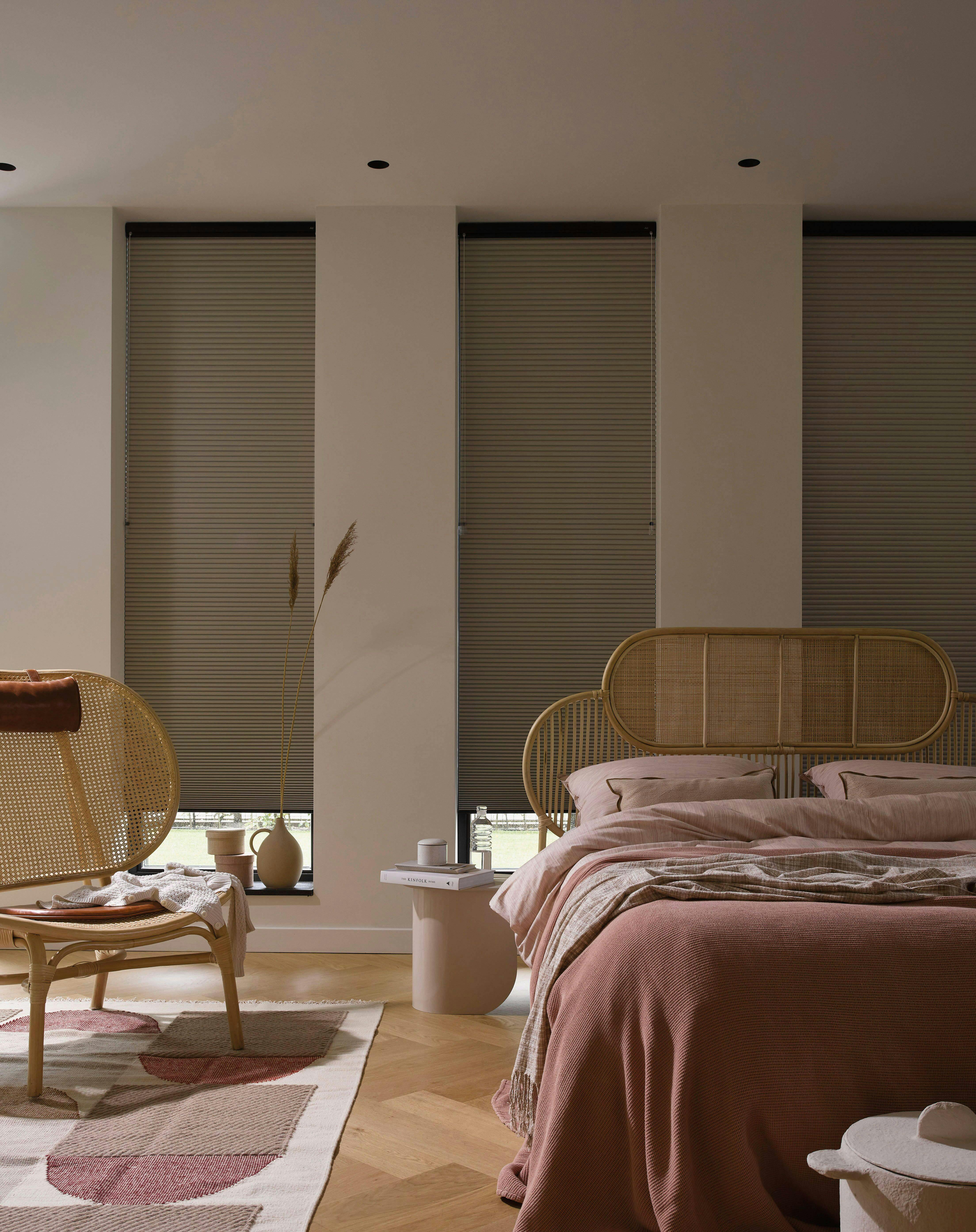 Pastel bedroom with beige Duette® shades on windows