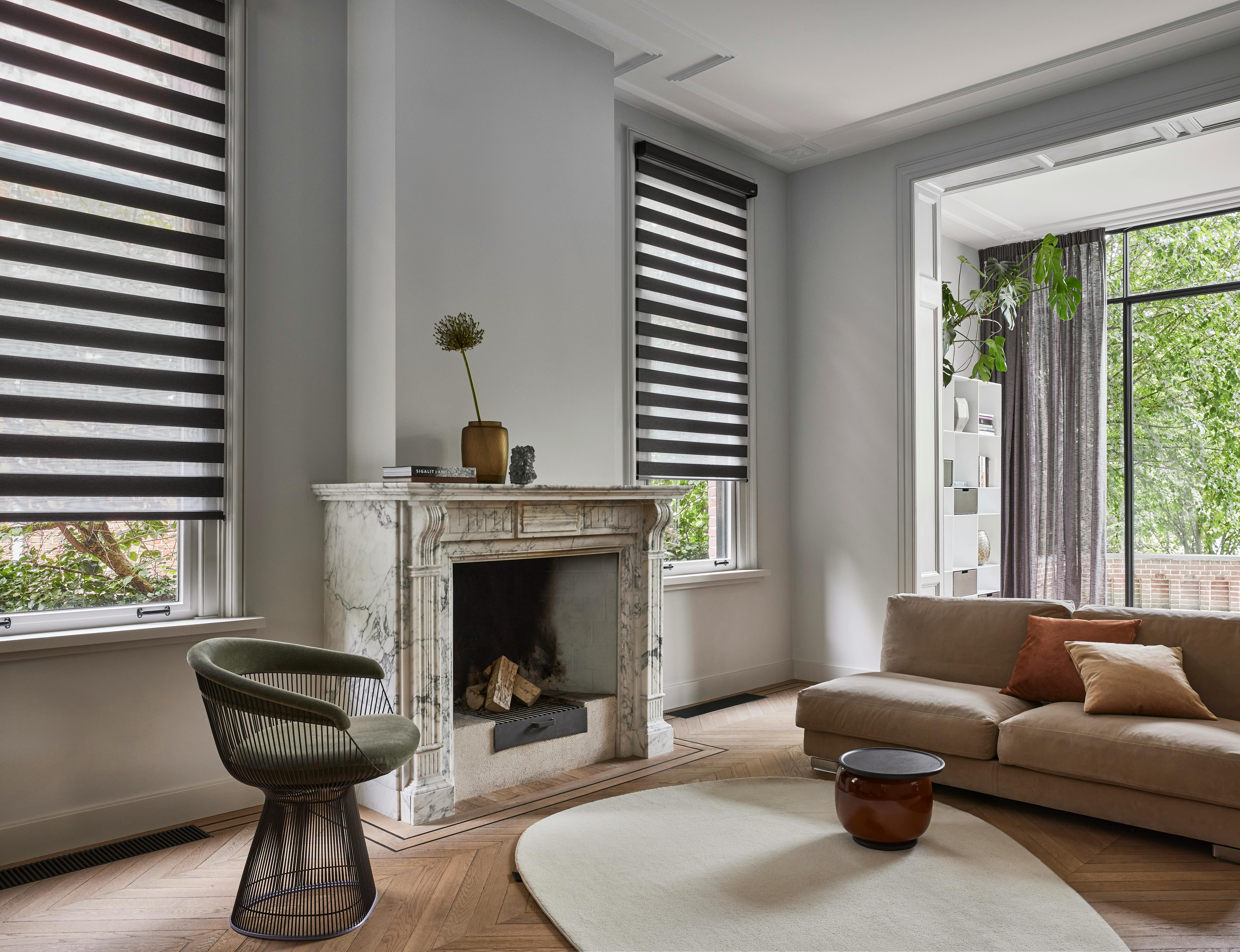 A spacious living room with brown duo roller blinds on windows