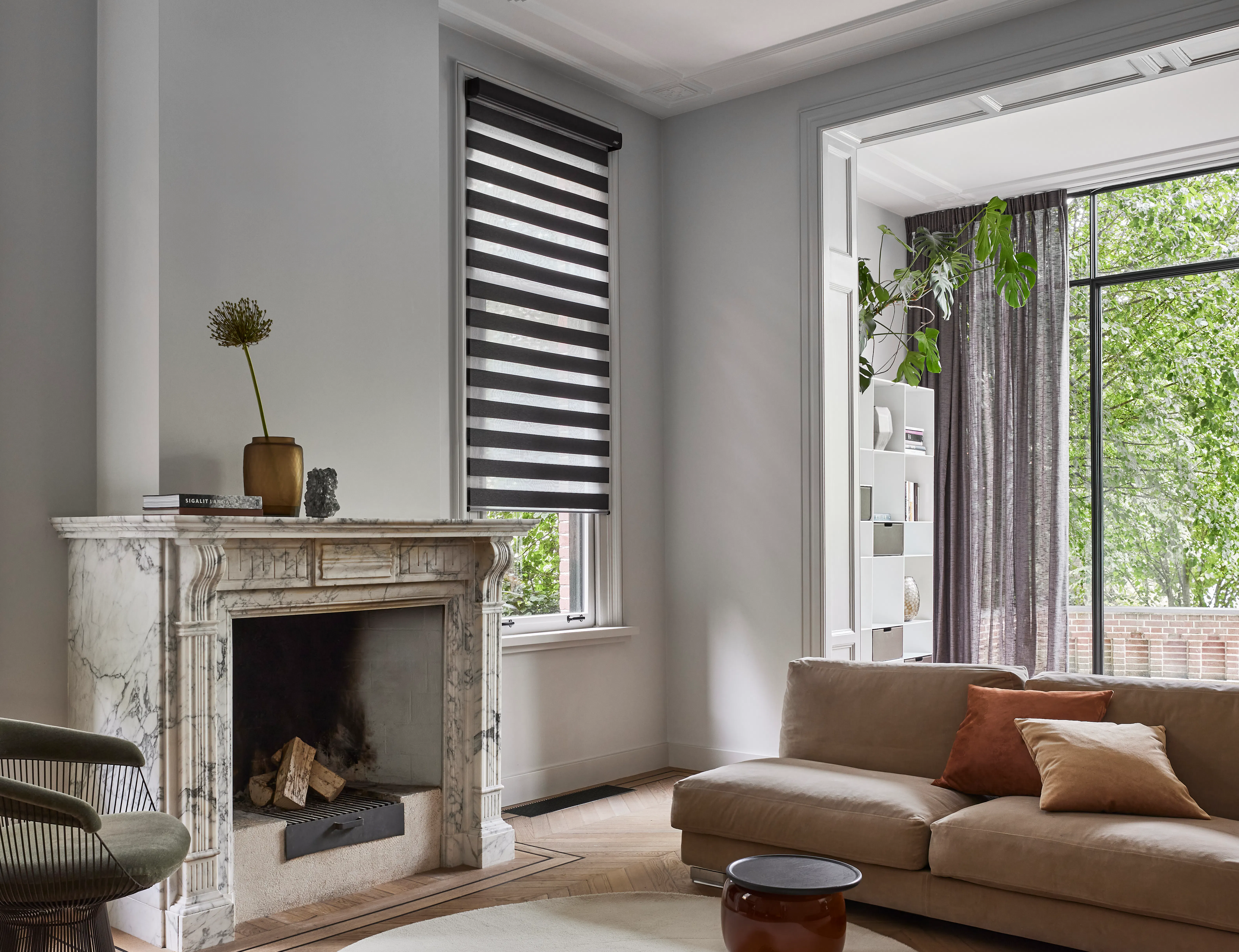A spacious living room with brown Twist® roller blinds on windows