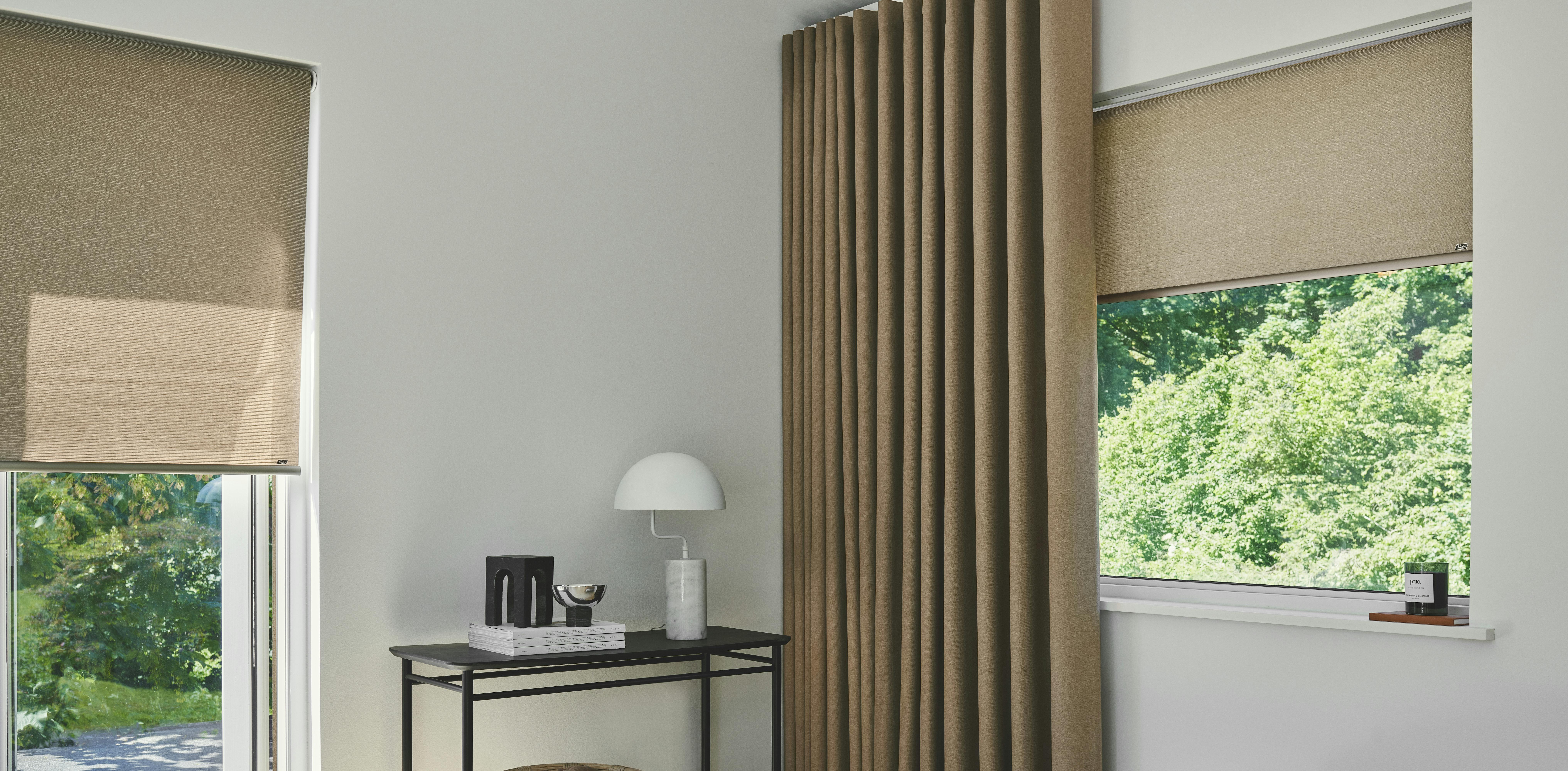 Modern bedroom with beige roller blinds on a window and patio door