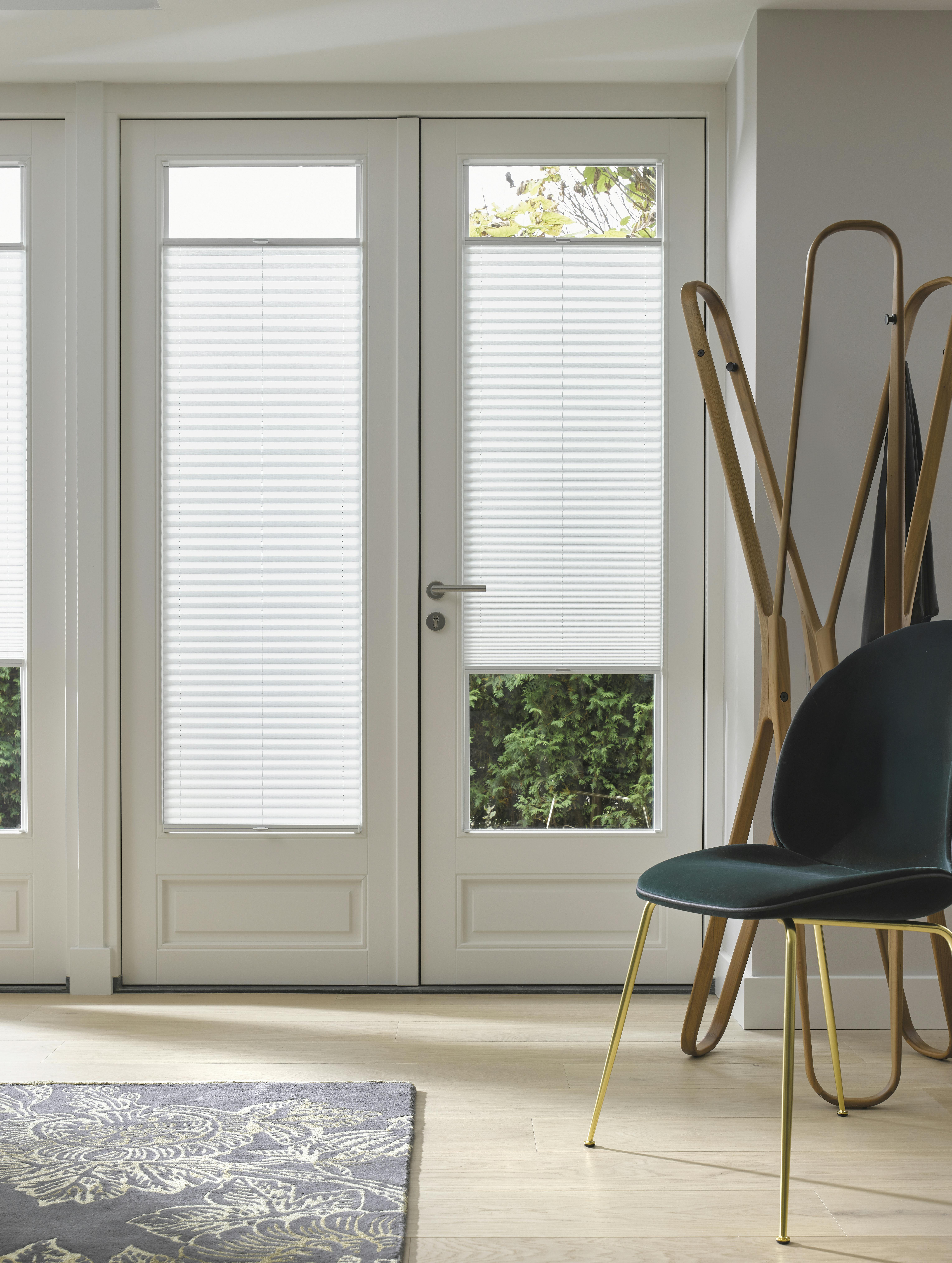 White plisse shades on patio doors