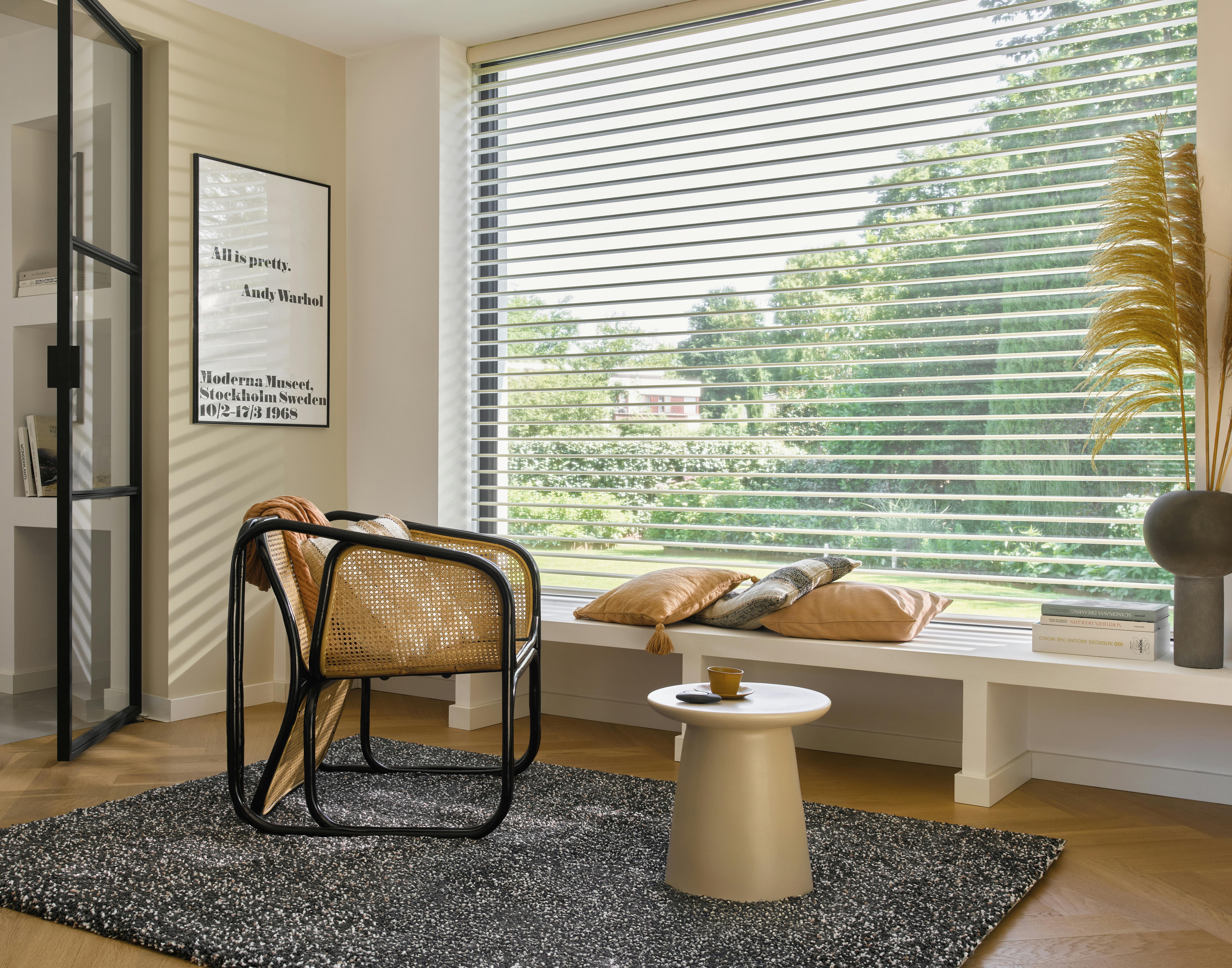 Light room with white Silhouette® shades on a large window 
