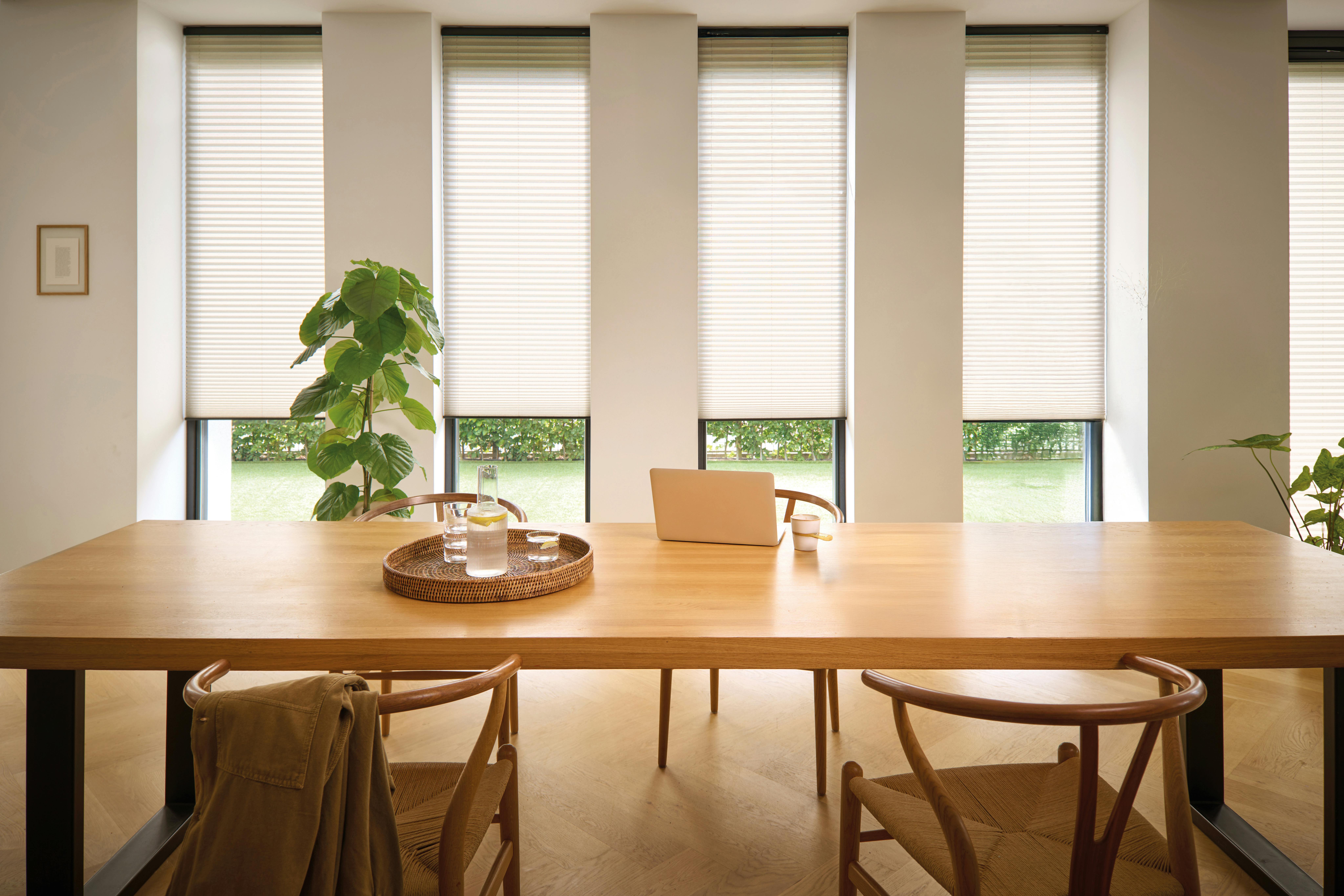 Light dining room with white plissé shades
on windows