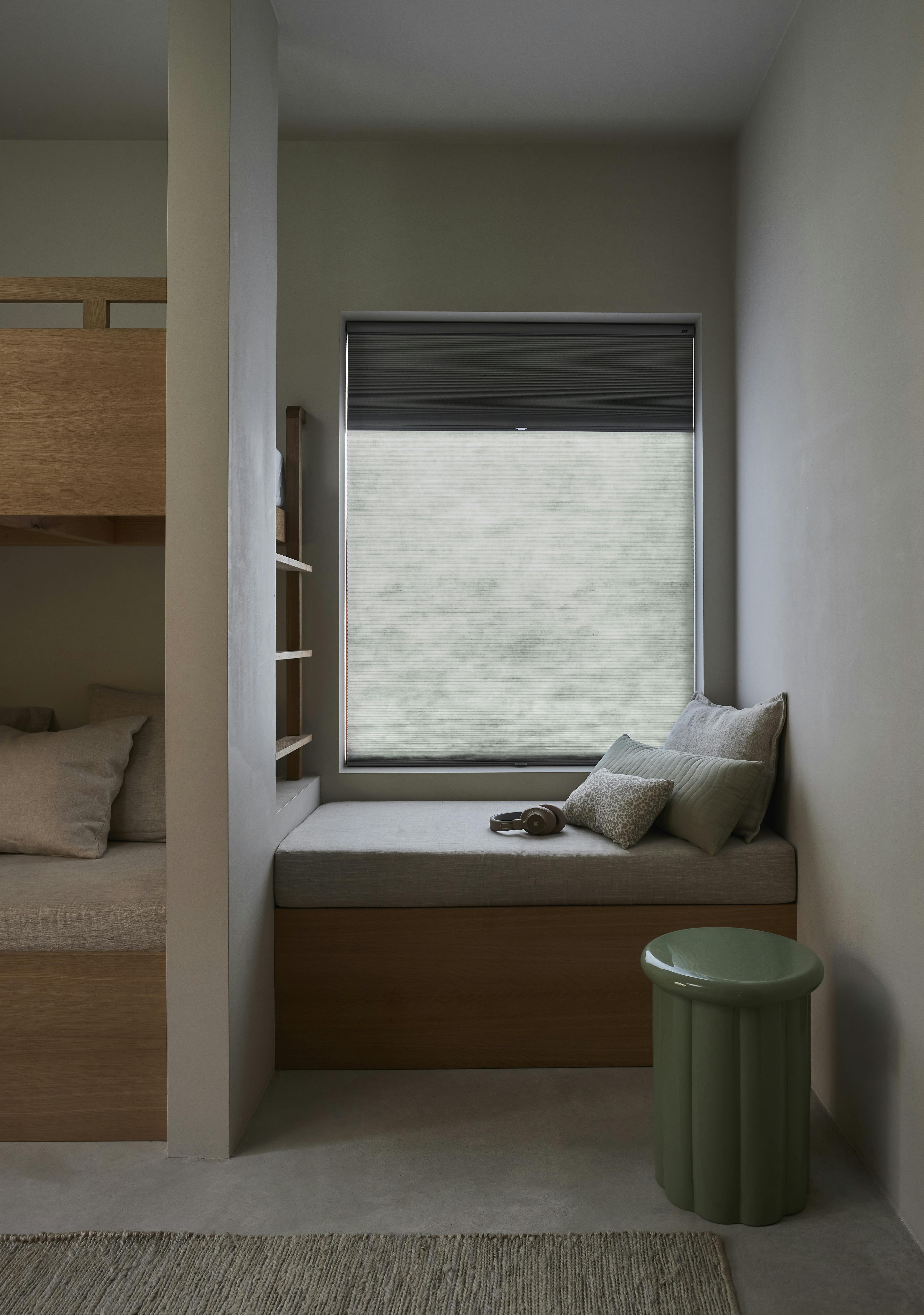 Duette® shades open in a bedroom window