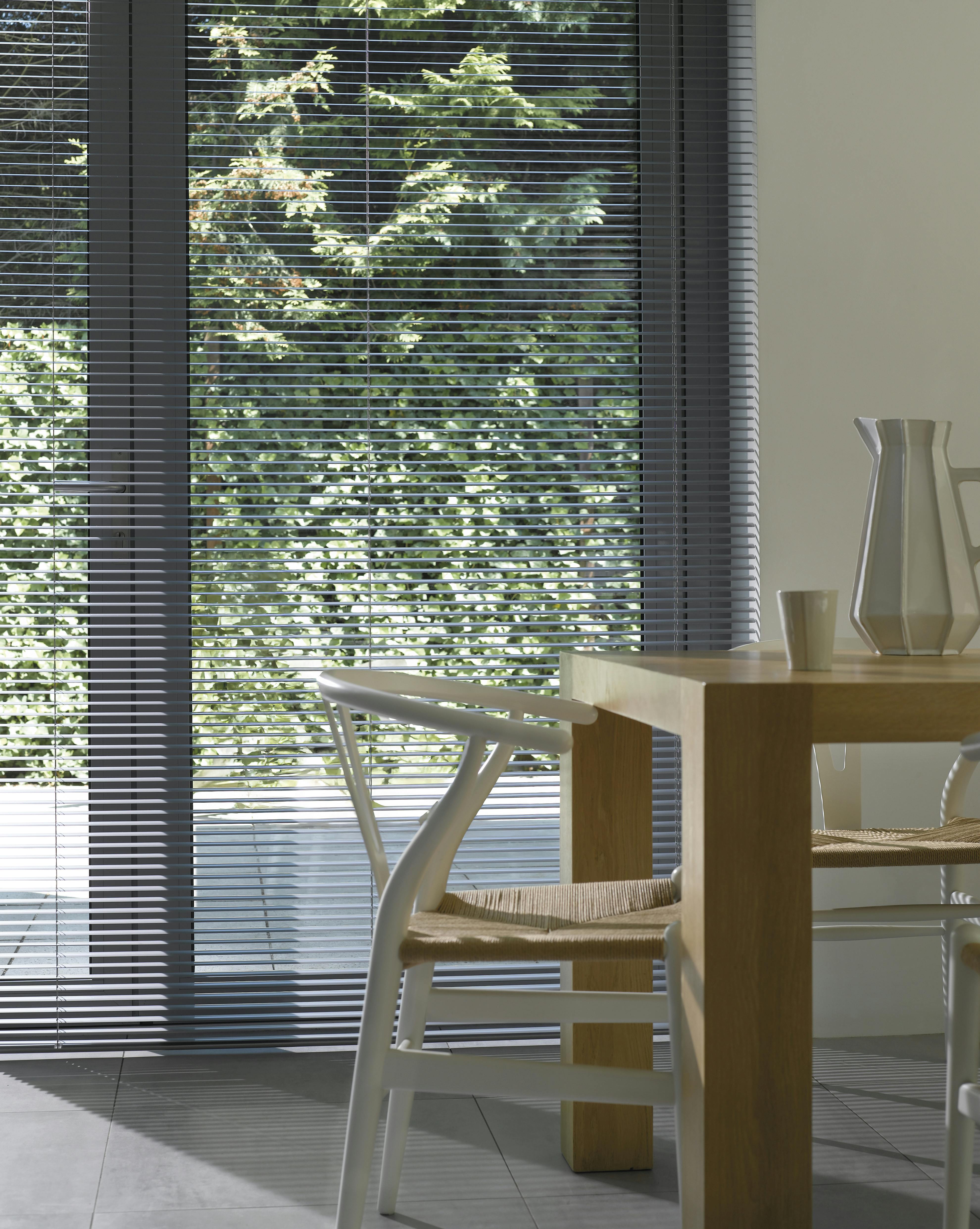 Venetian blinds in an open position in a dining room 