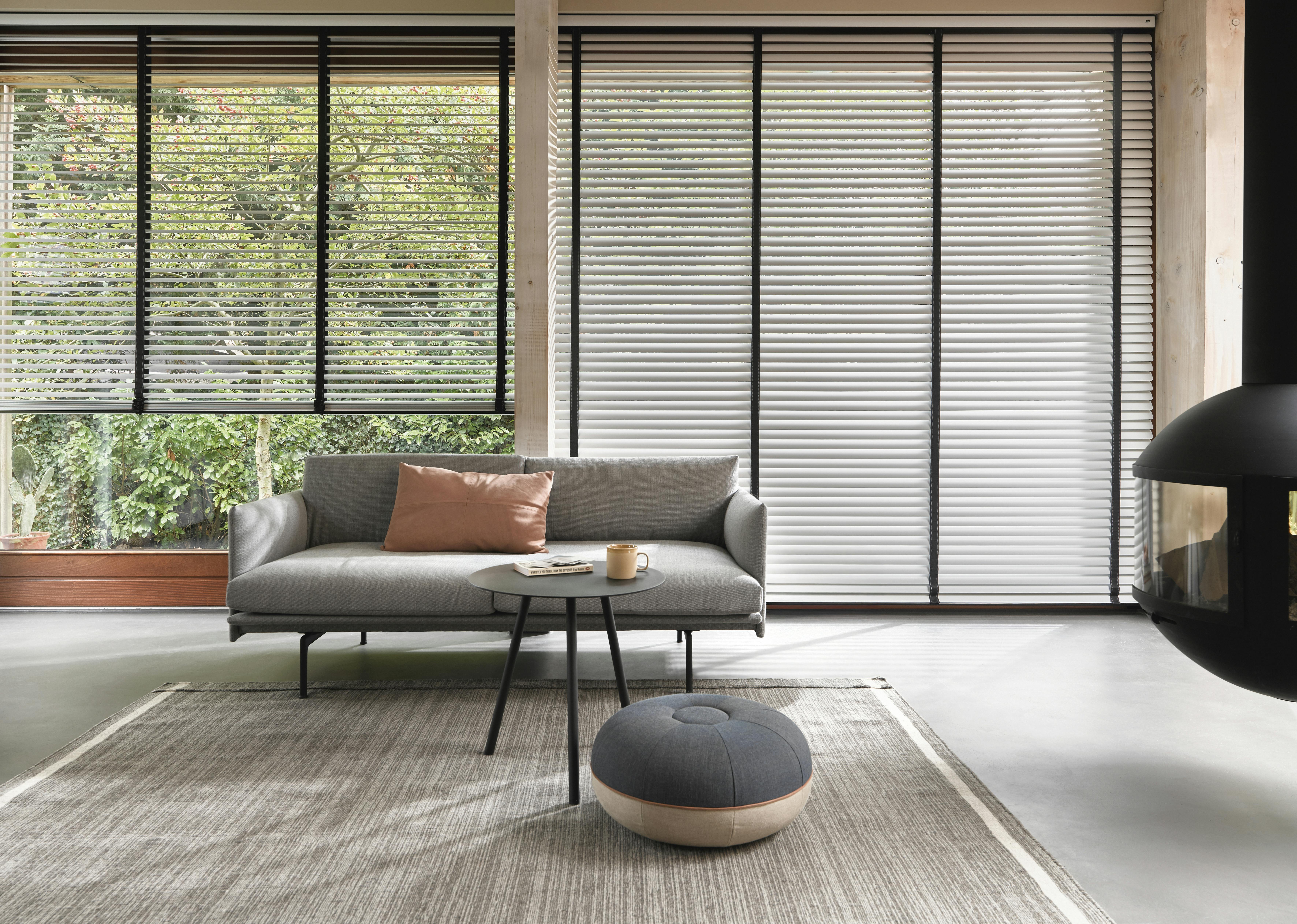 Light grey venetian blinds in open and closed position in a living room 
